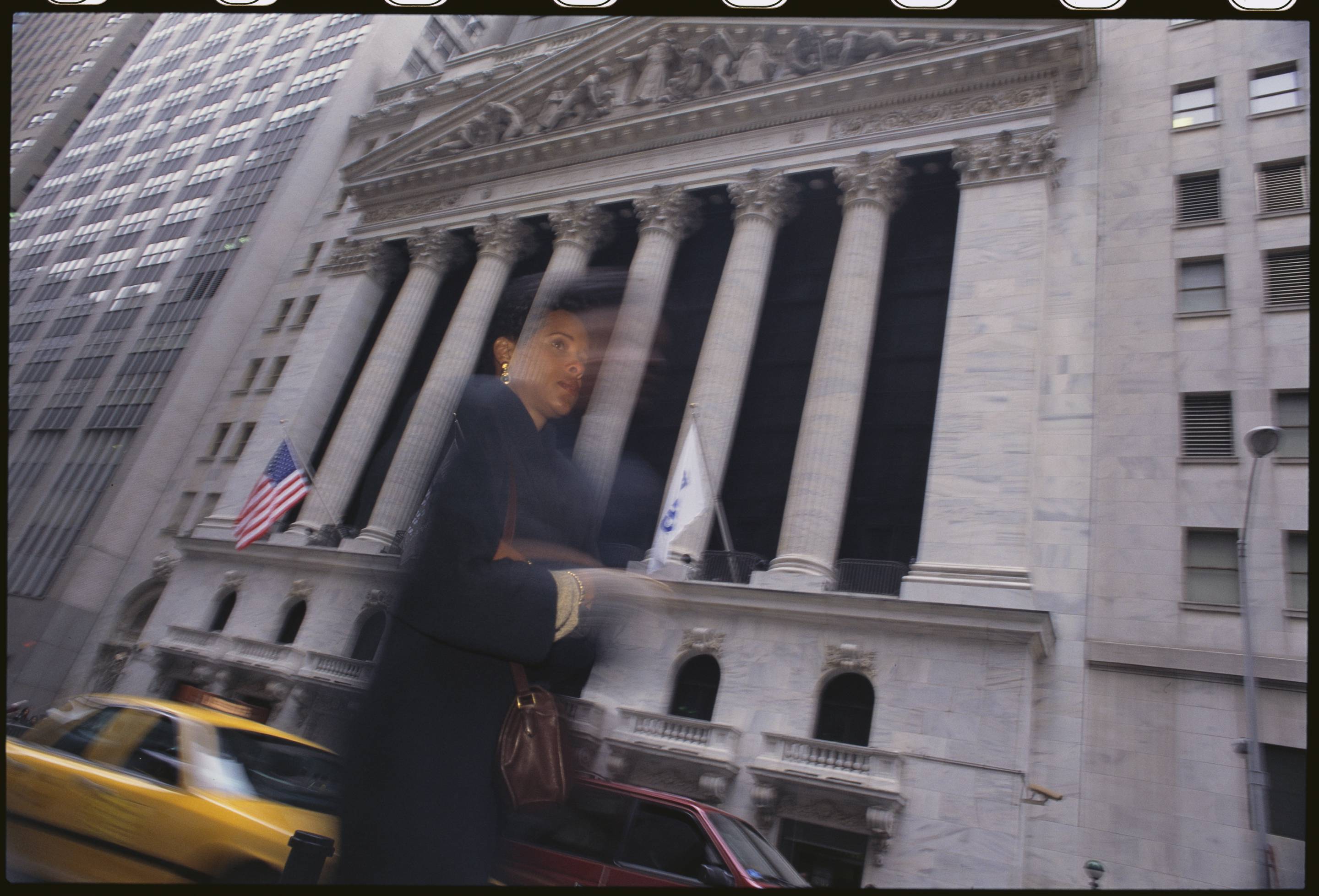 Woman Walks Past the New York Stock Exchange