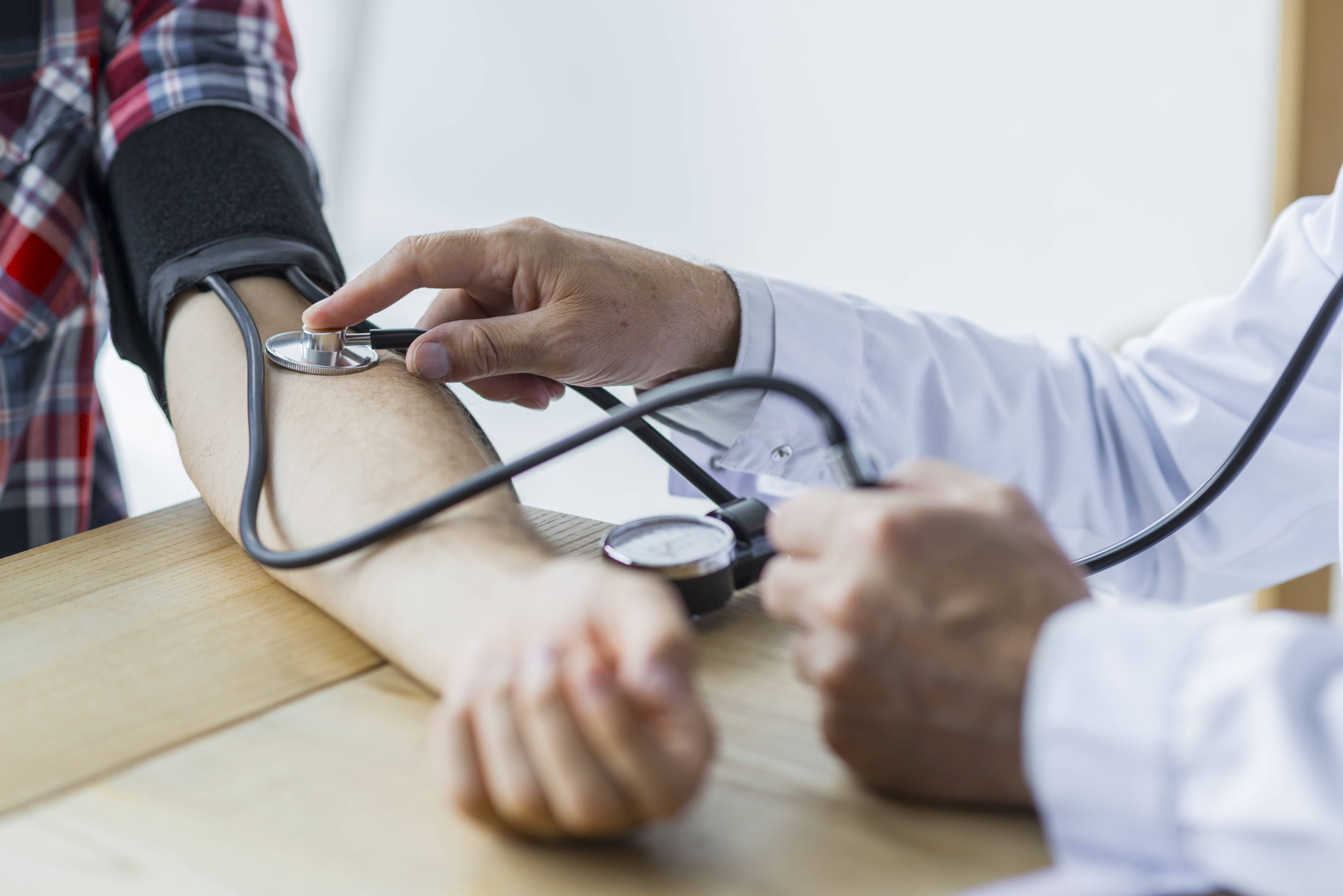 Doctor Measuring arterial blood pressure woman patient on right arm Health care in hospita