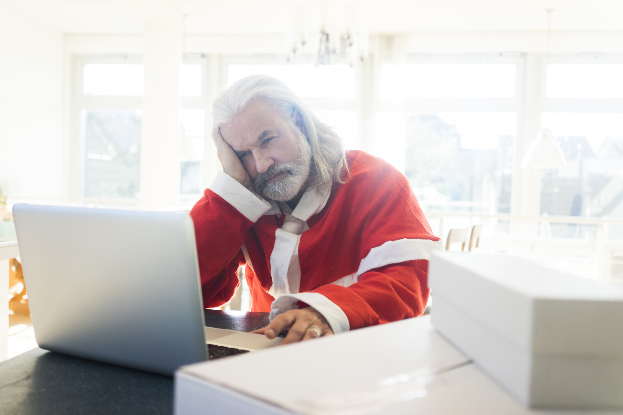 Frustrated Santa using laptop at home