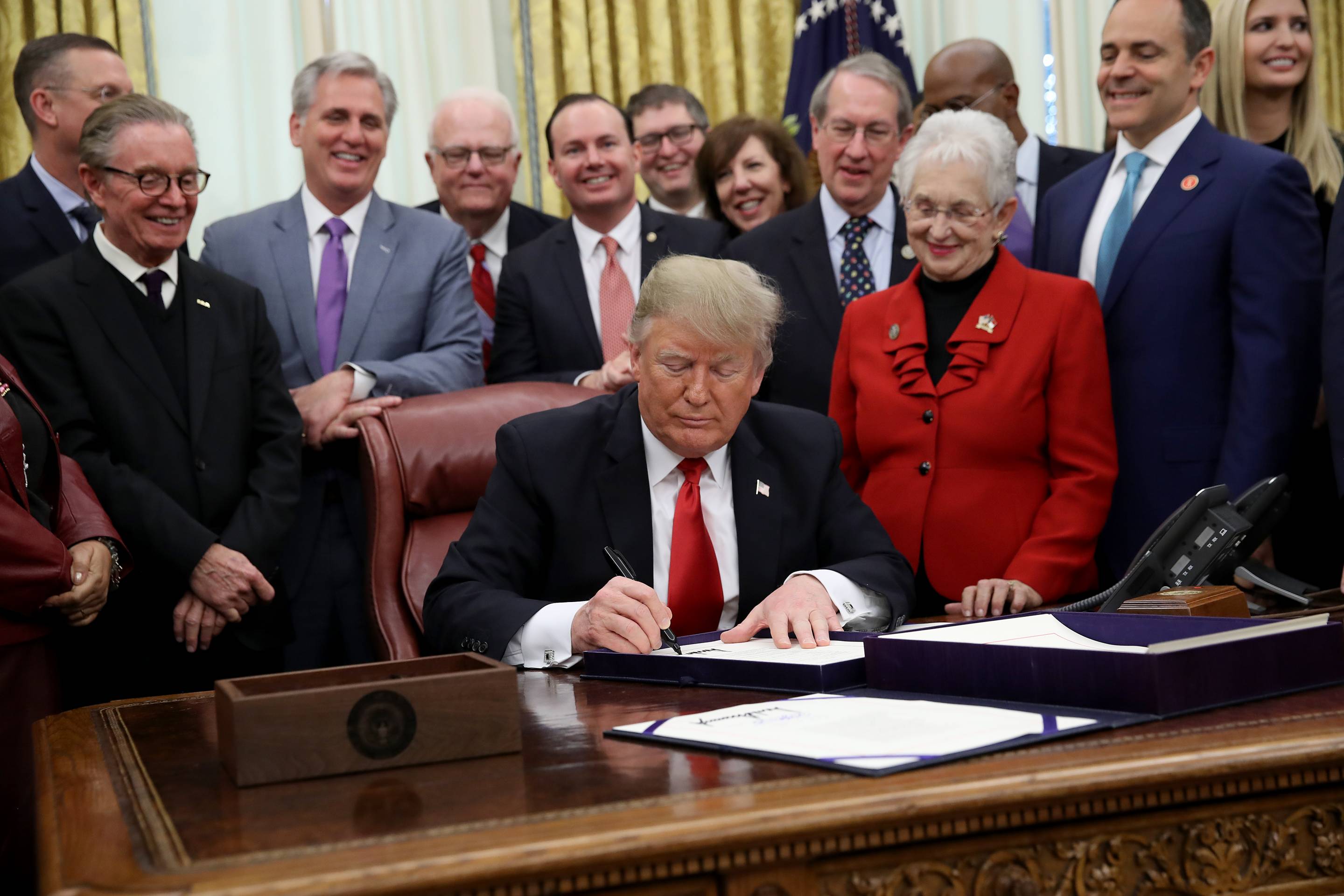 President Donald Trump signs the First Step Act in the Oval Office of the White House on Dec. 21, 2018.