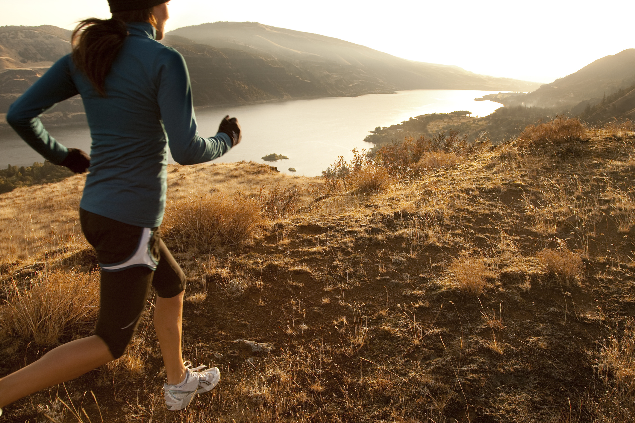 An athletic woman trail running.