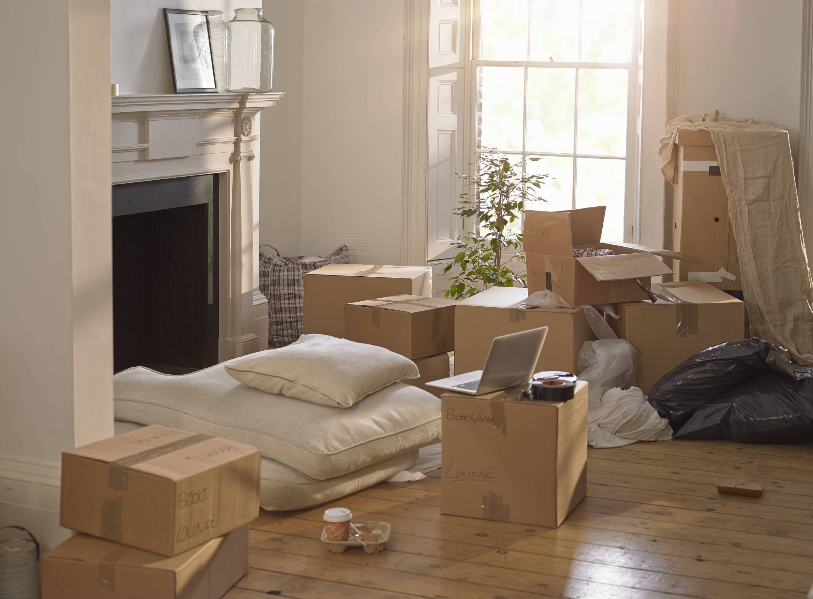 A room full of packing boxes and a laptop