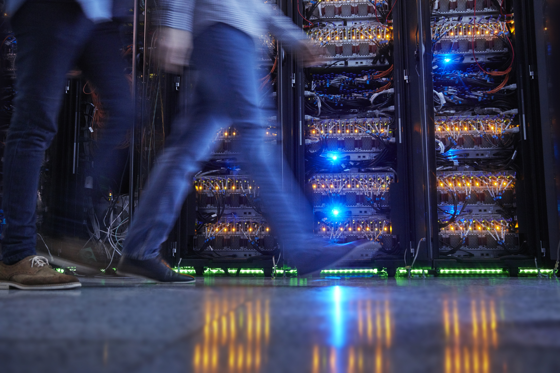 IT technicians walking in dark server room