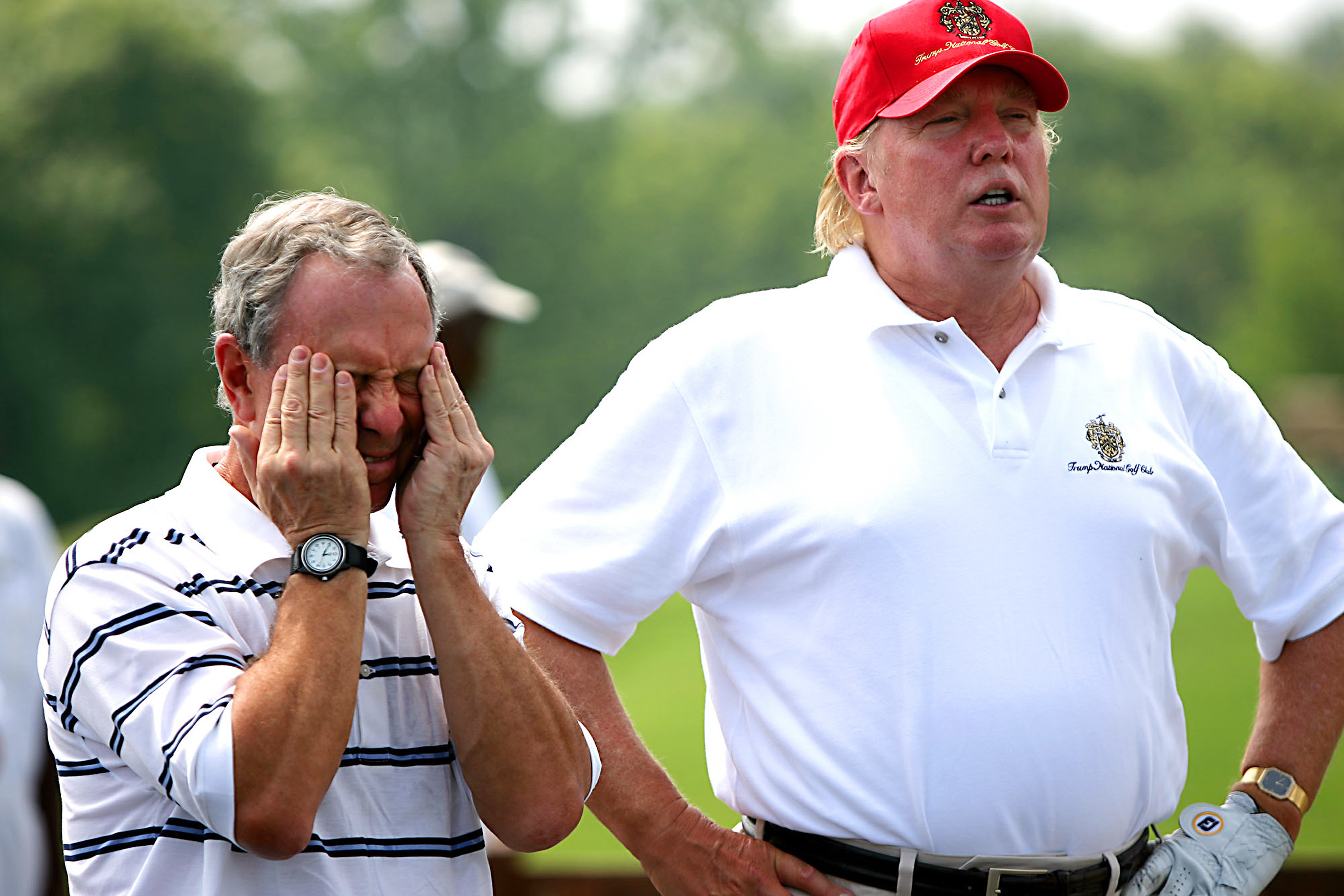 Mayor Michael Bloomberg rubs his temples as he and Donald Tr