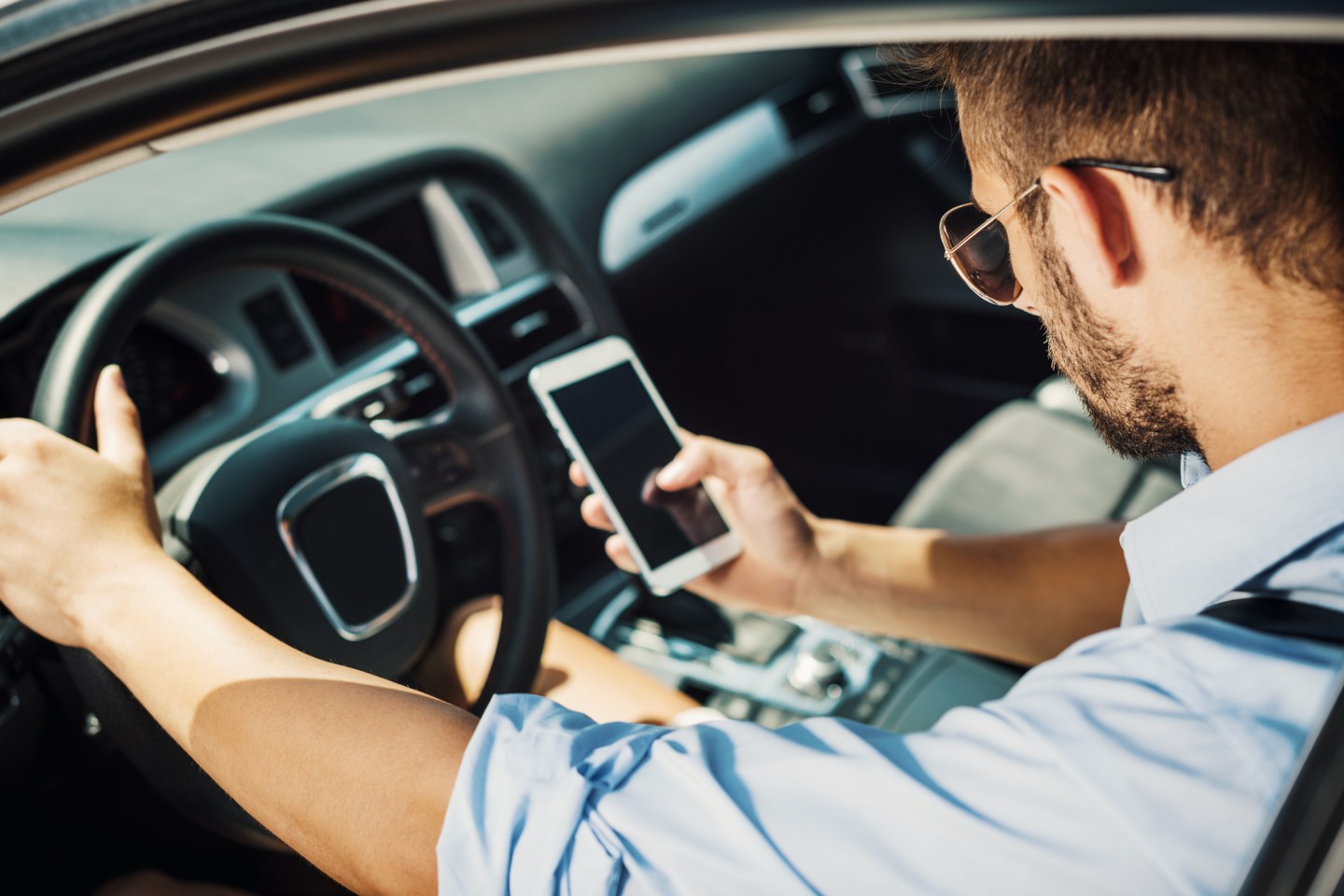 Young man driving car for crowdsourced taxi