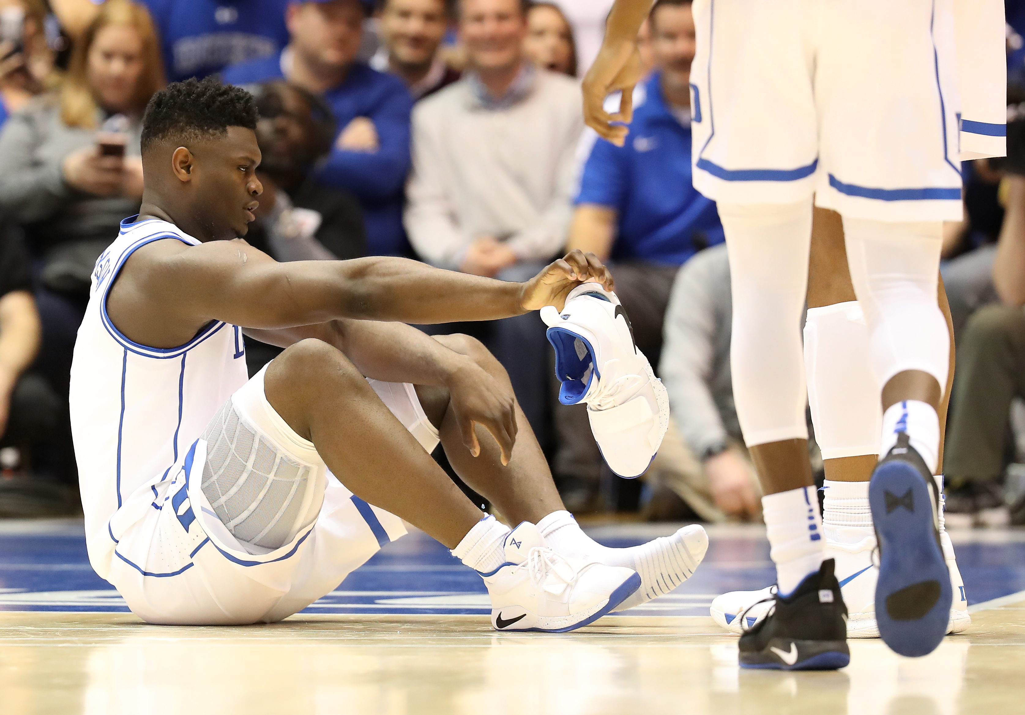 Duke's Zion Williamson reacts after his shoe breaks during a game on Feb. 20, 2019, in Durham, N.C.