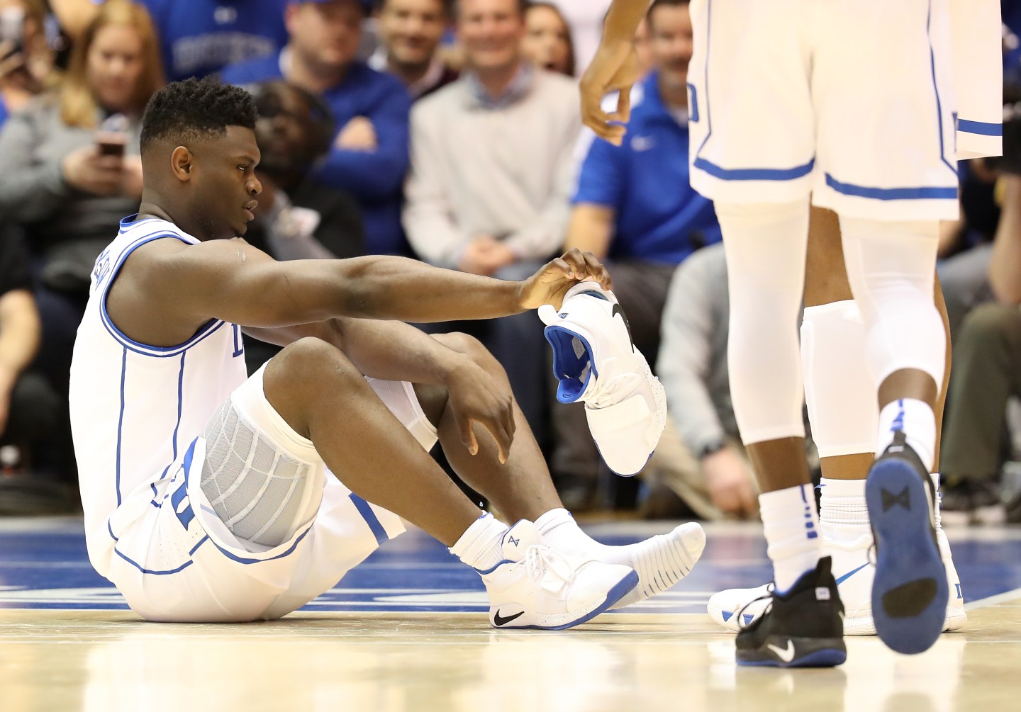 Duke's Zion Williamson reacts after his shoe breaks during a game on Feb. 20, 2019, in Durham, N.C.