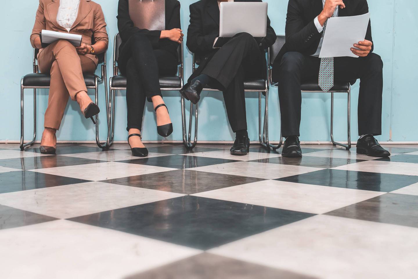 Low Section Of People Waiting For Interview On Chair