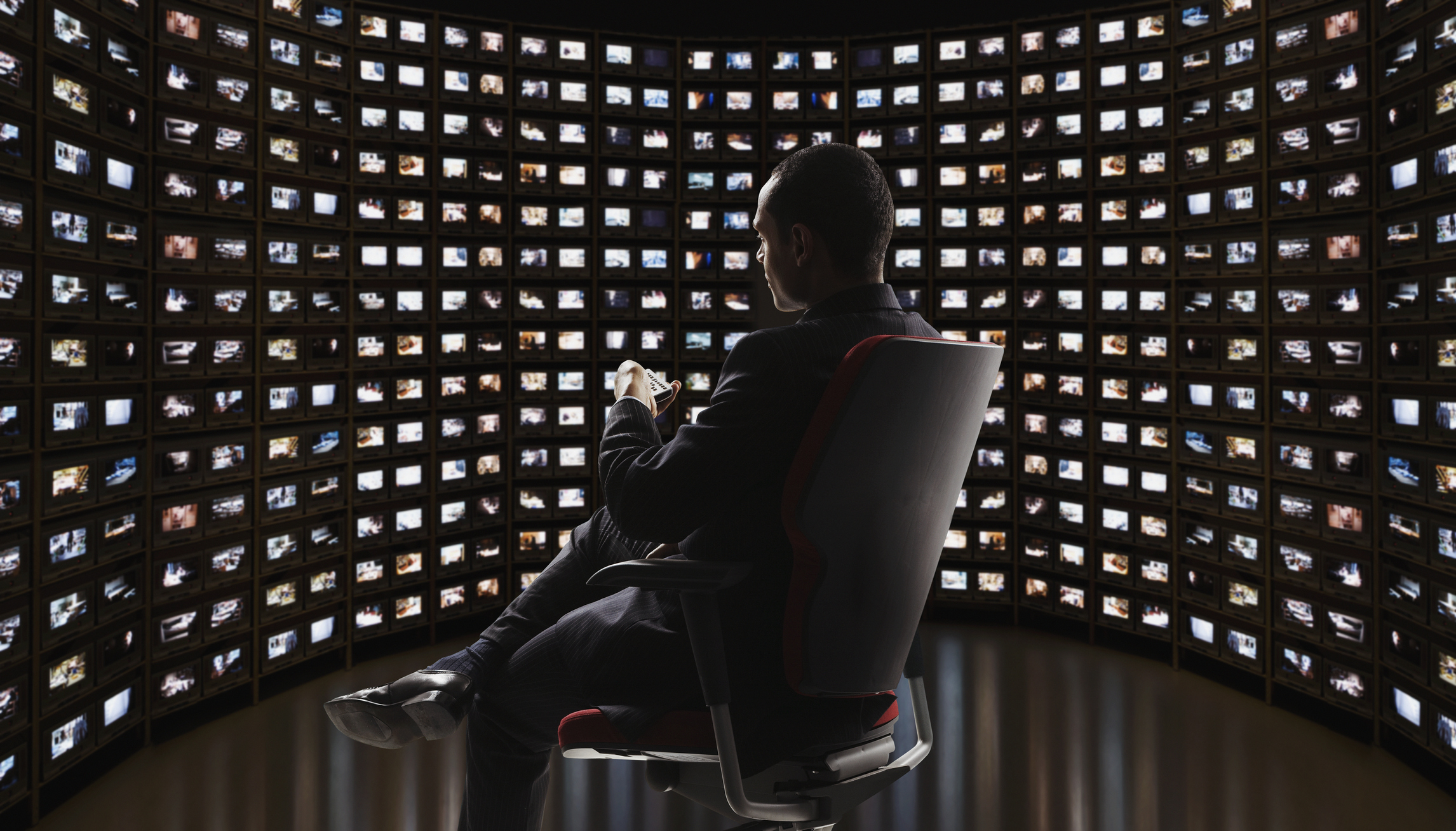 Man watching video on monitors