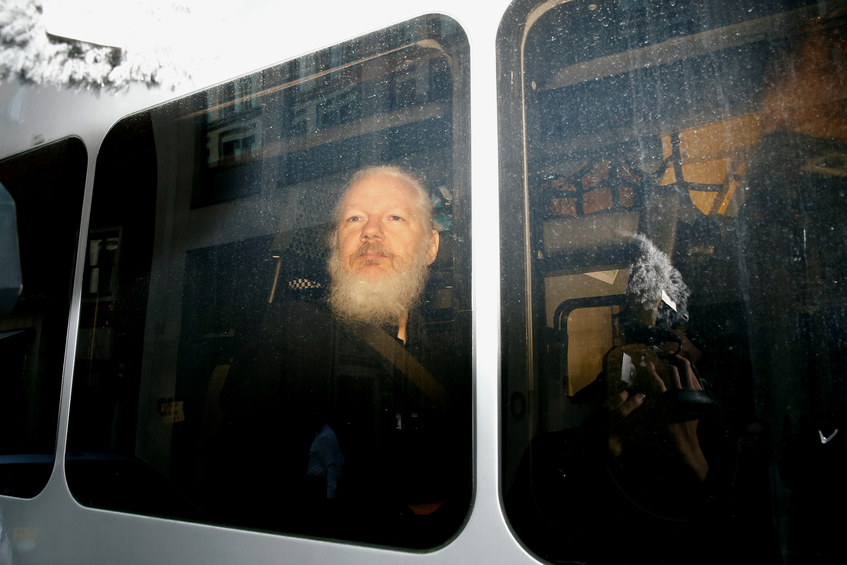 WikiLeaks founder Julian Assange is seen in a police van, after he was arrested by British police, in London