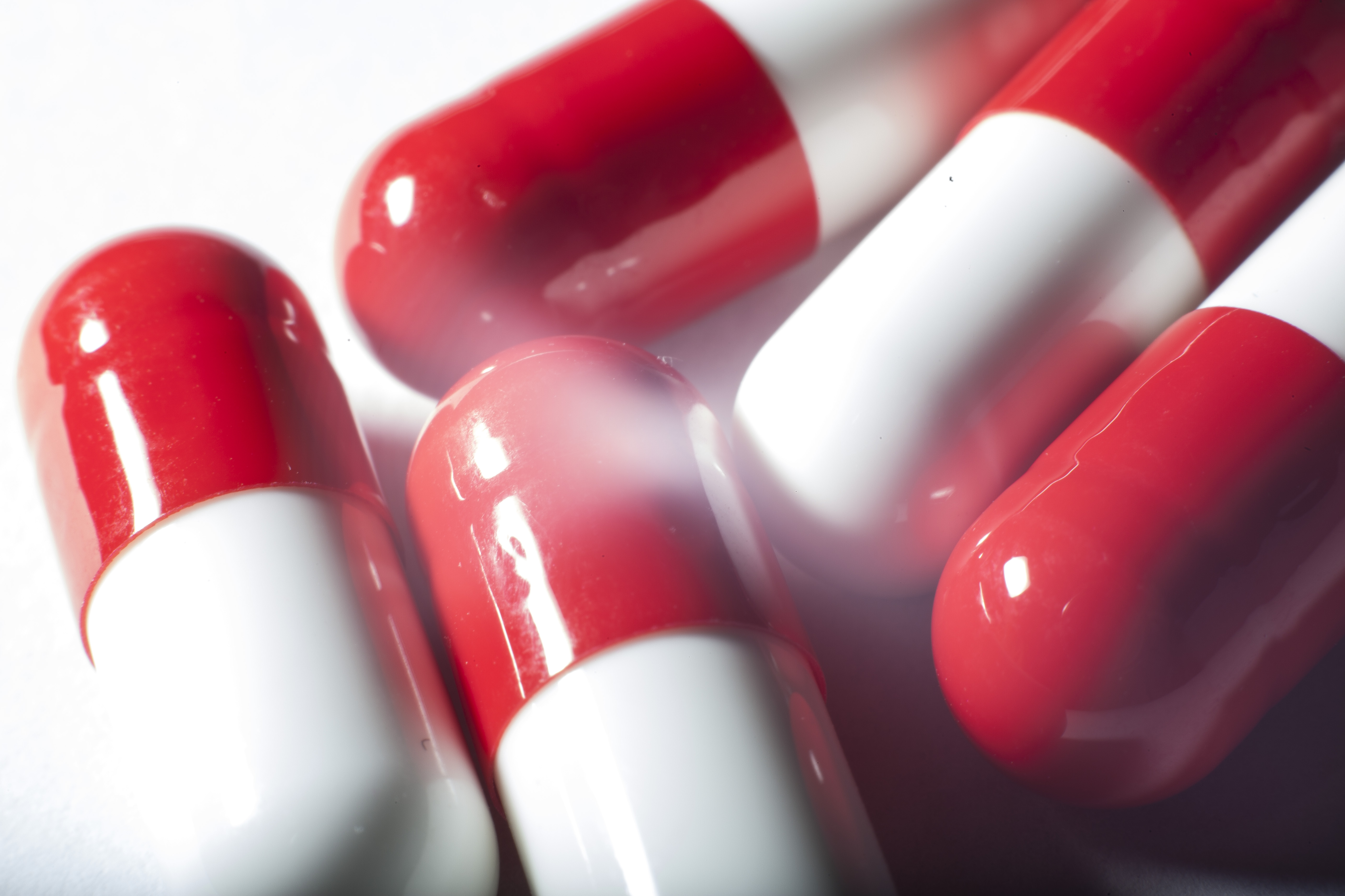 Red and white pills on a table