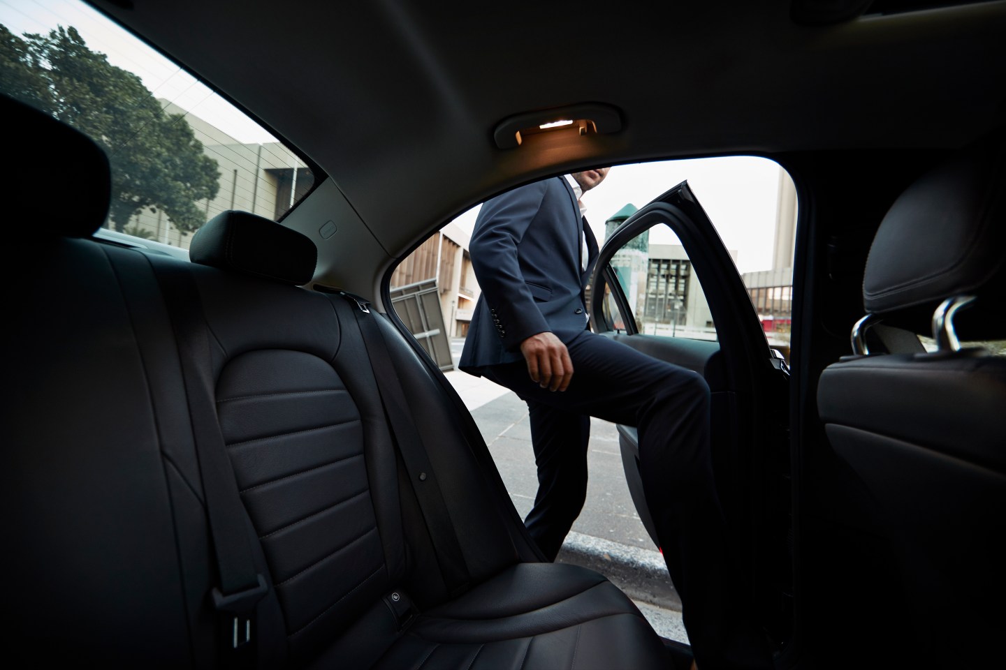 Man getting into a rideshare car