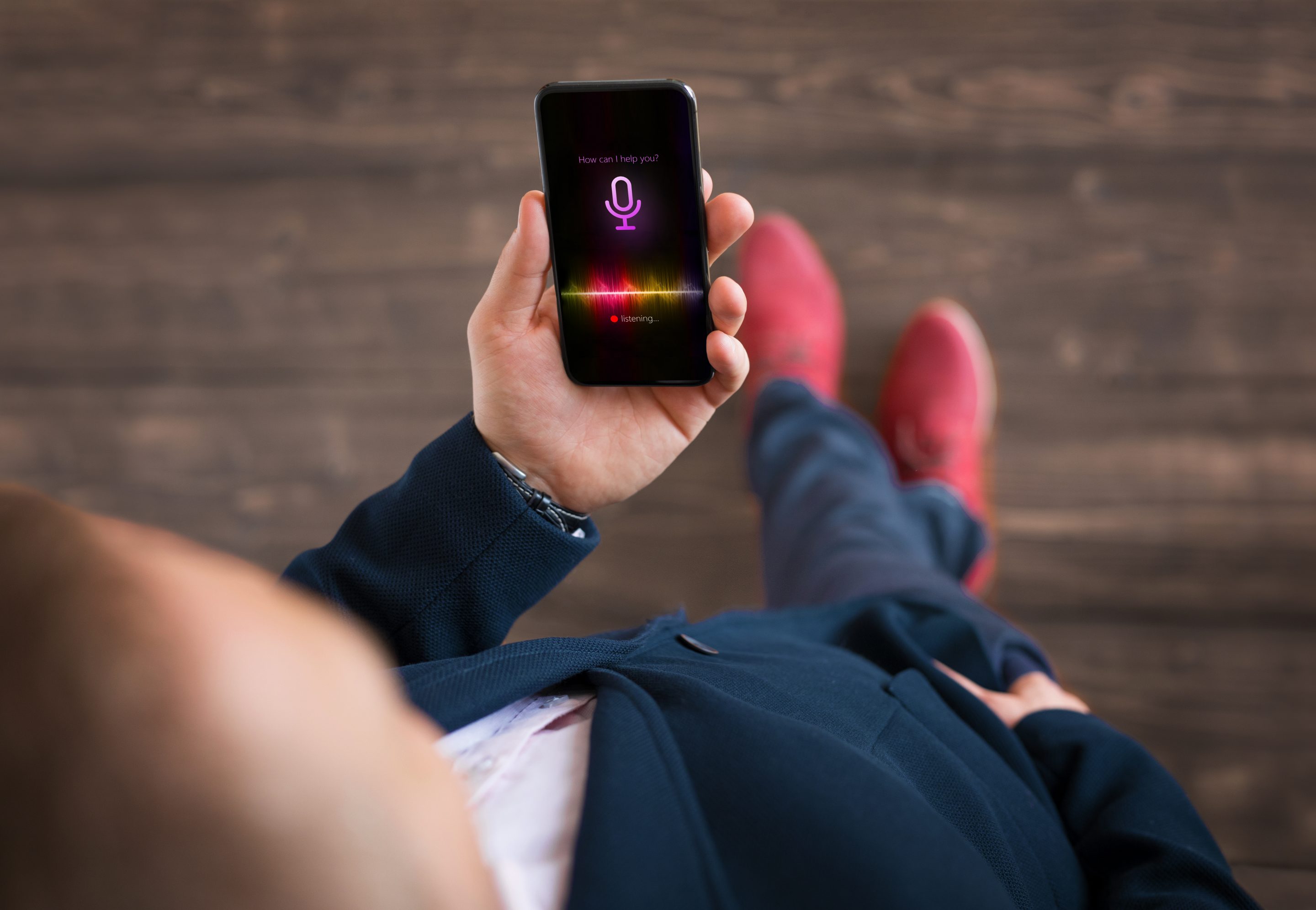 Man using mobile phone's virtual assistant.