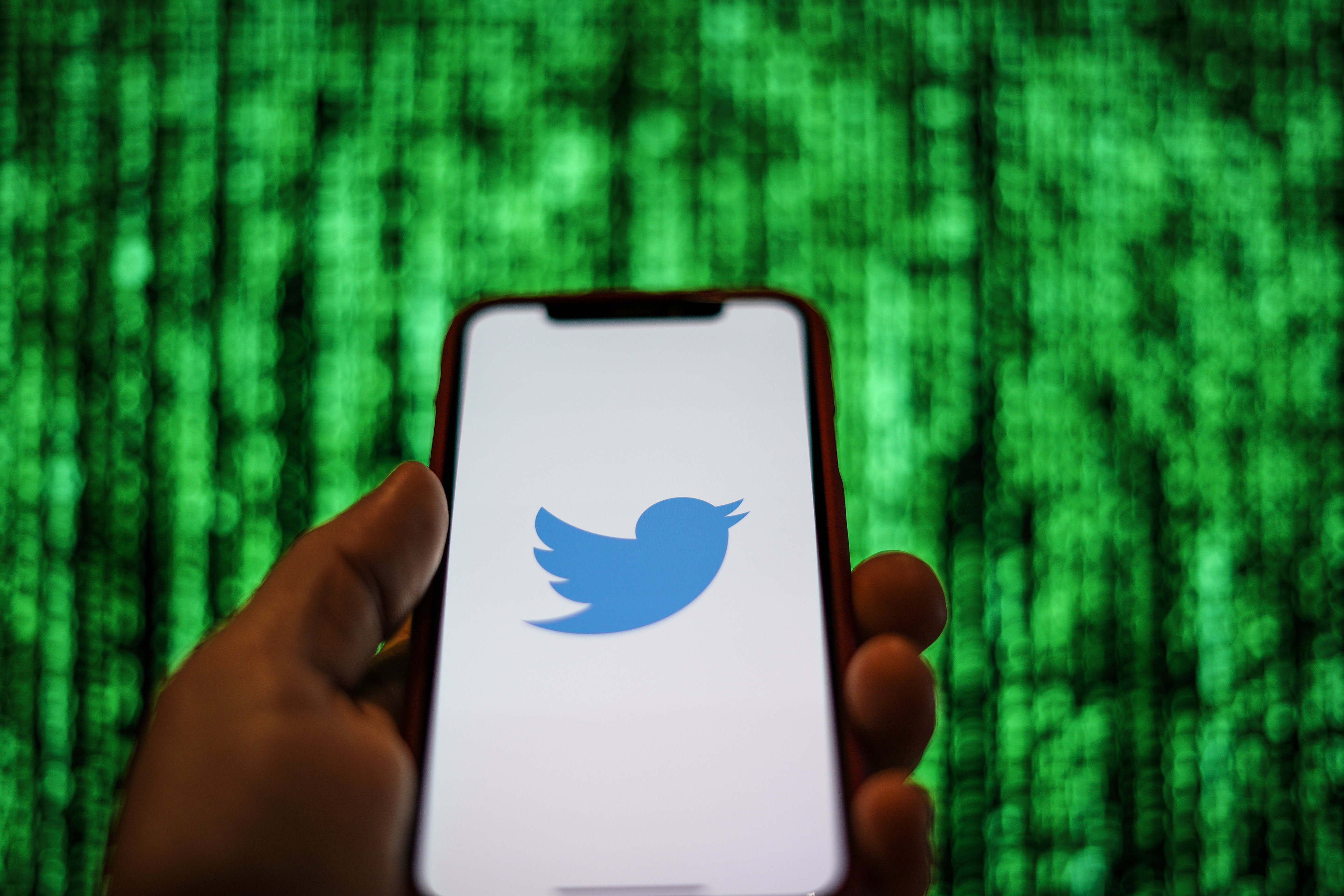 The Twitter logo is seen displayed on a mobile device in front of a screen with data in this photo illustration in Warsaw, Poland on March 19, 2019. (Photo by Jaap Arriens/NurPhoto via Getty Images)