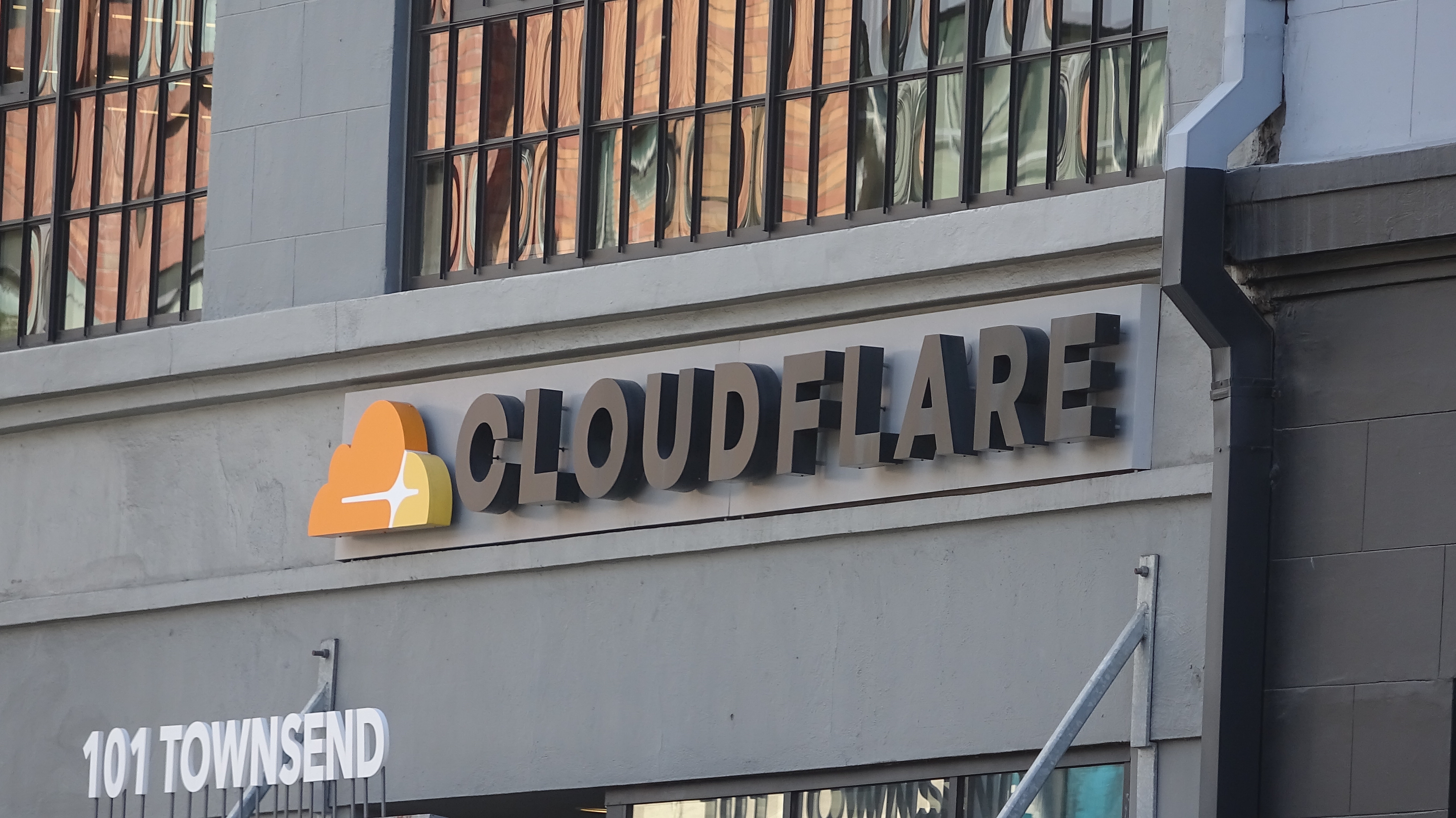 Close-up of logo on facade at headquarters of cyber security company Cloudflare in the South of Market (SoMA) neighborhood of San Francisco, California.