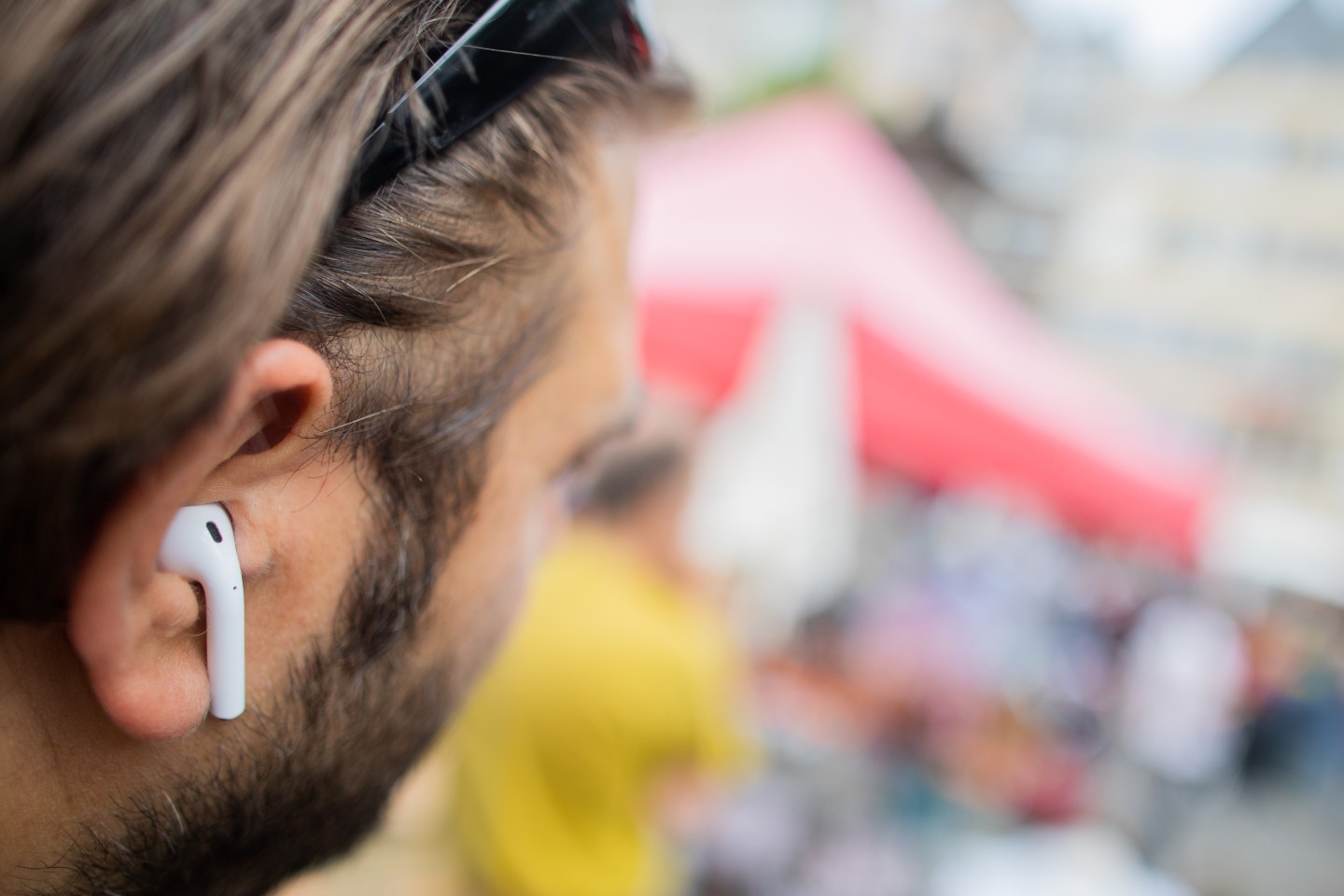 A man wears AirPods, Apple's wireless headphones