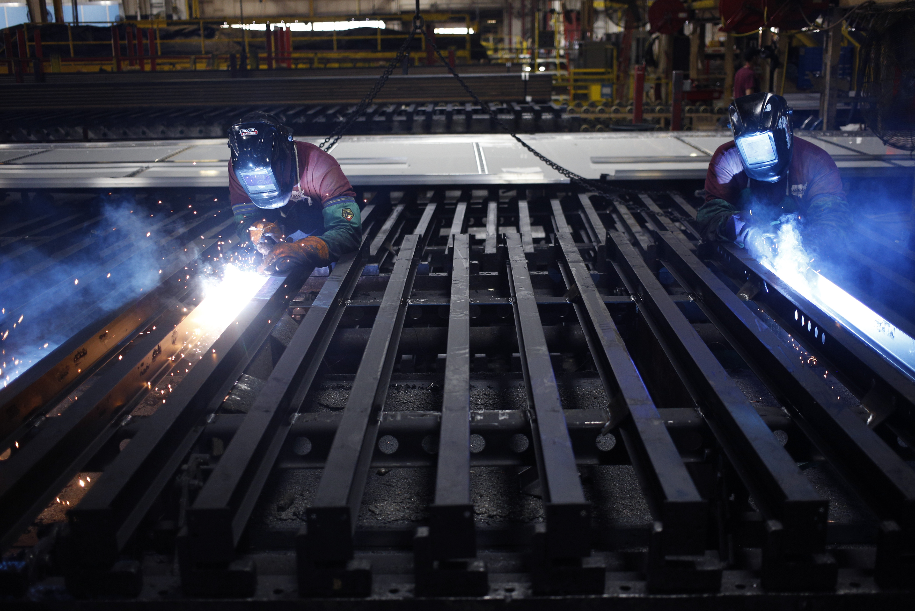 Workers use welding torches on semi-trailer frames at the Wabash National Corp. manufacturing facility in Lafayette, Indiana, U.S., on Tuesday, Aug. 13, 2019. Markit is scheduled to release manufacturing figures on August 22. Photographer: Luke Sharrett/Bloomberg via Getty Images
