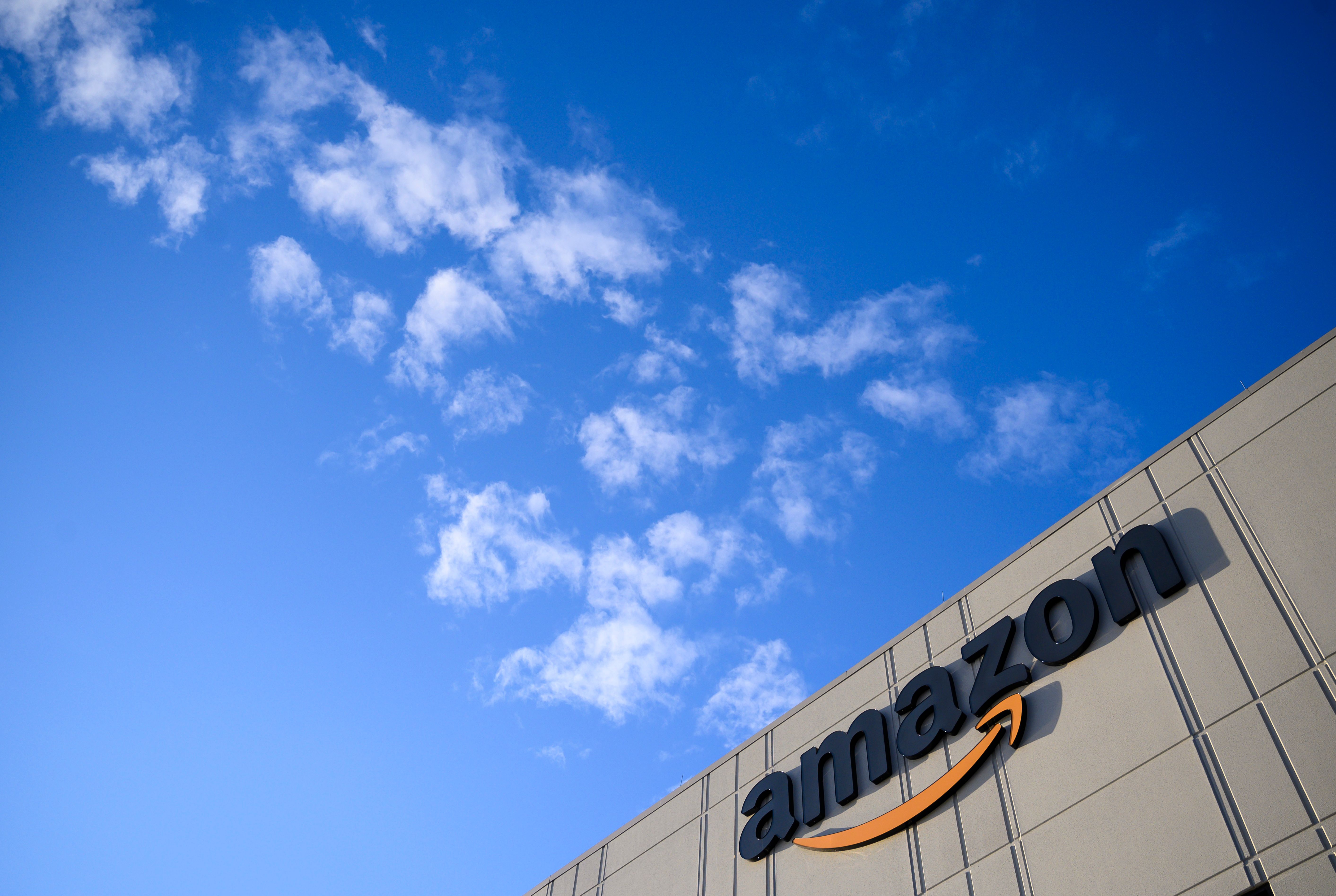 This photo shows the Amazon logo at the 855,000-square-foot Amazon fulfillment center in Staten Island, one of the five boroughs of New York City, on February 5, 2019. - Inside a huge warehouse on Staten Island thousands of robots are busy distributing thousands of items sold by the giant of online sales, Amazon. (Photo by Johannes EISELE / AFP)