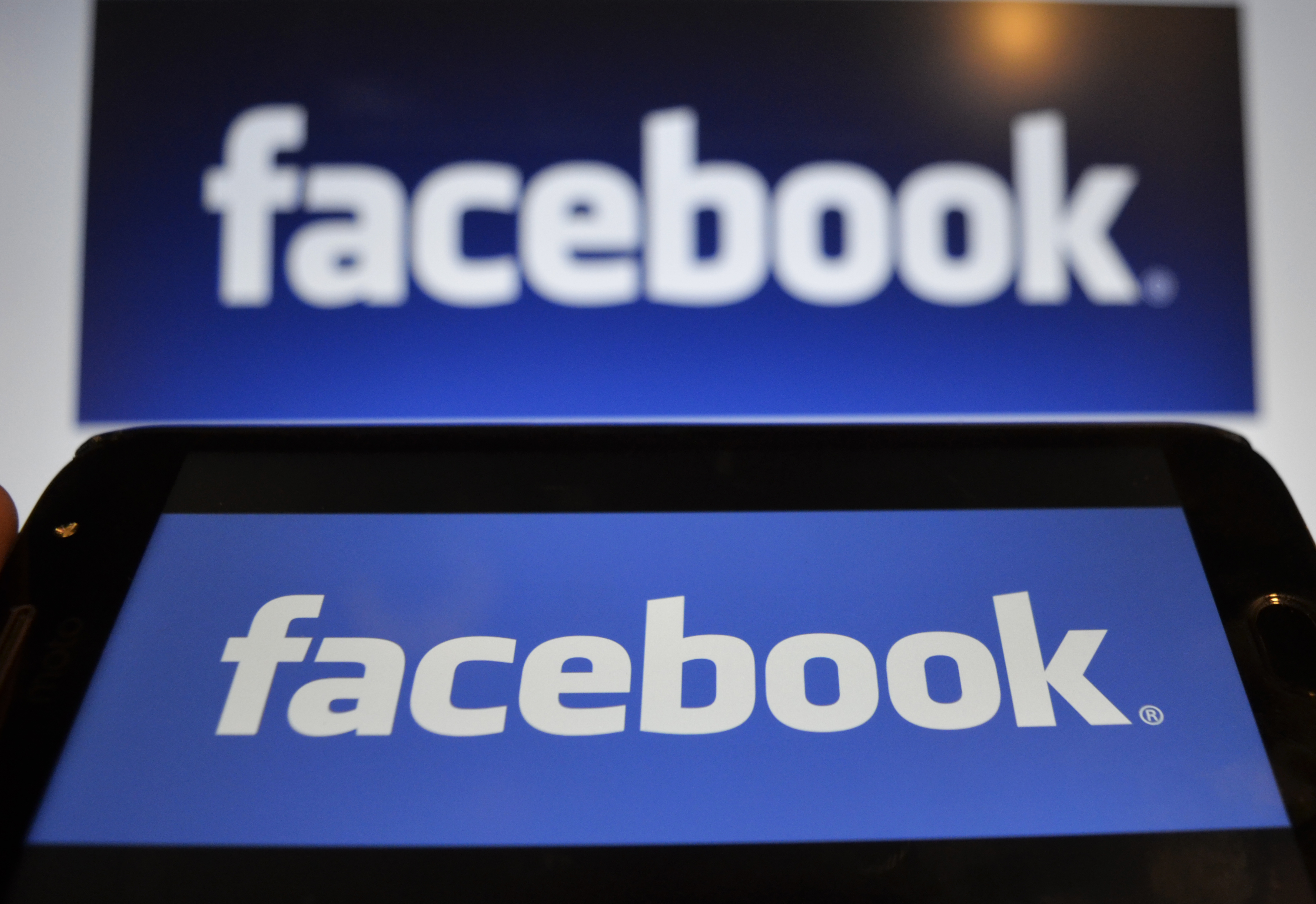In this photo illustration a Facebook logo can be seen on a mobile screen as well as on a laptop screen, Kolkata, India, 16 August, 2019.Facebook users sues the world's largest social media network over a 2018 data breach which failed to warn data risks tied to its single sign-on tools even though it protected its employees according to an Indian media report.
