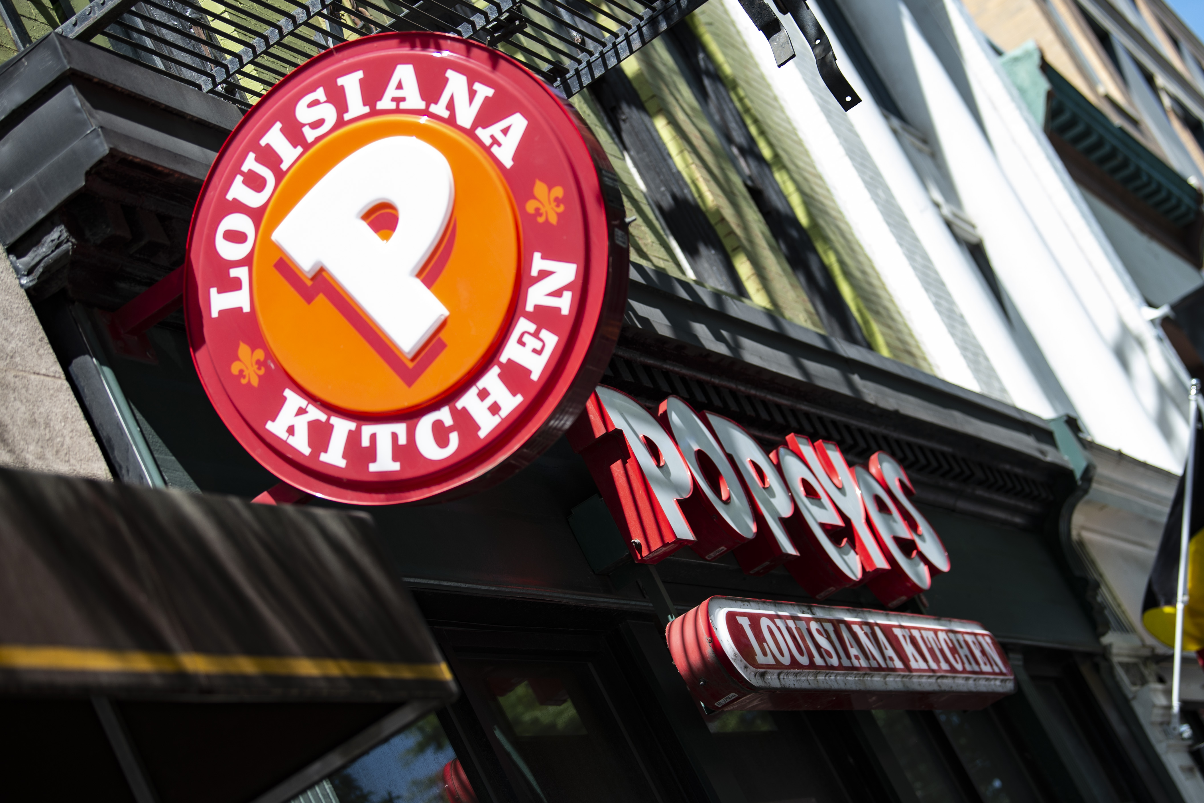 A Popeyes fast food chain restaurant is seen on August 30, 2019 on a street of Washington D.C. - Chick it out! US restaurant chain Popeyes launched a fried chicken sandwich which became such a social media sensation, the company has run out of stock nationwide, leaving would-be consumers crying fowl. On August 12, Popeyes unveiled its latest offering: a deep fried chicken breast on a brioche roll, with spicy mayonnaise and pickle slices. The fried chicken chain said they would let customers know when sandwiches are back. (Photo by Eric BARADAT / AFP) (Photo credit should read ERIC BARADAT/AFP/Getty Images)