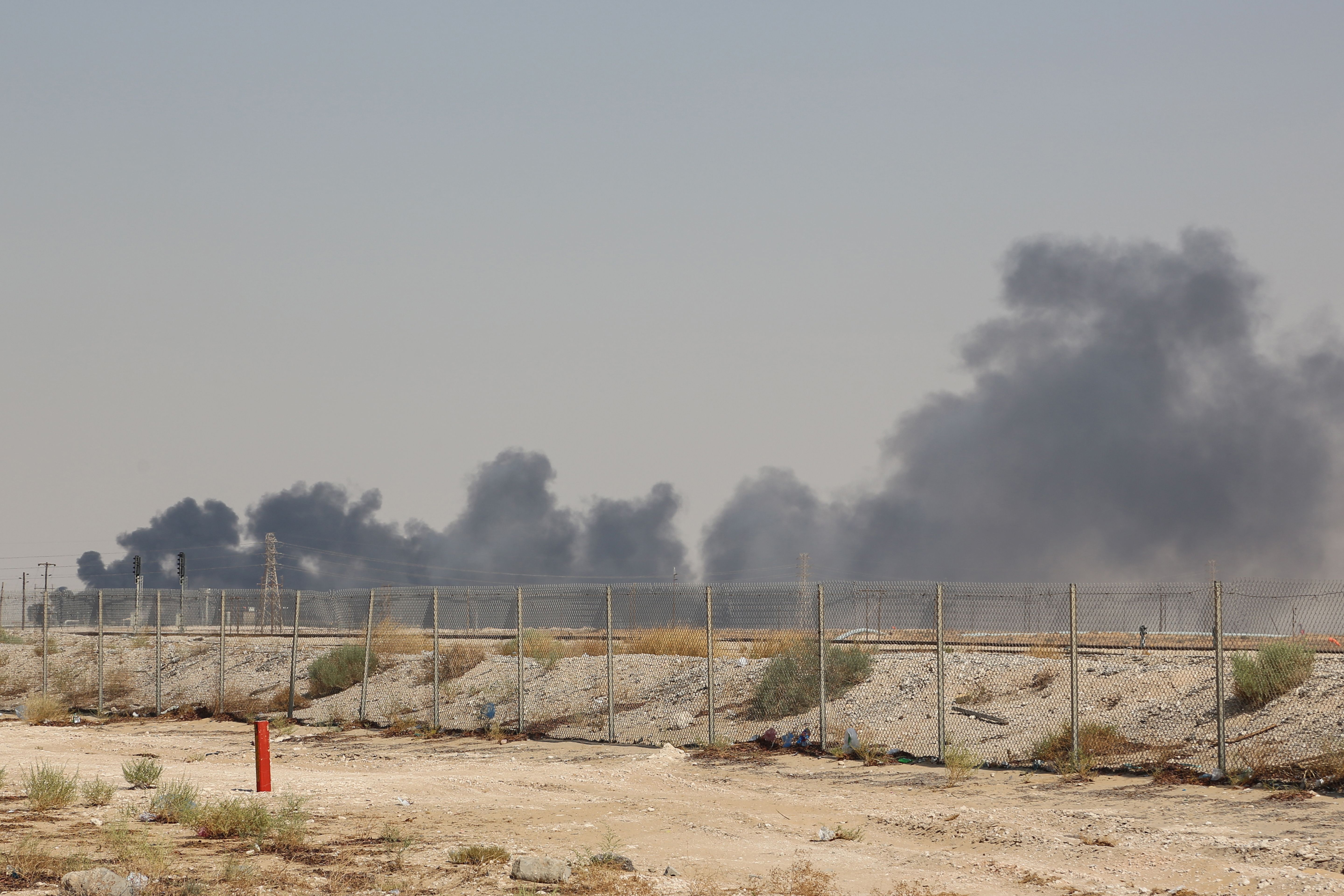 TOPSHOT - Smoke billows from an Aramco oil facility in Abqaiq about 60km (37 miles) southwest of Dhahran in Saudi Arabia's eastern province on September 14, 2019. - Drone attacks sparked fires at two Saudi Aramco oil facilities early today, the interior ministry said, in the latest assault on the state-owned energy giant as it prepares for a much-anticipated stock listing. Yemen's Iran-aligned Huthi rebels claimed the drone attacks, according to the group's Al-Masirah television. (Photo by - / AFP) (Photo credit should read -/AFP/Getty Images)