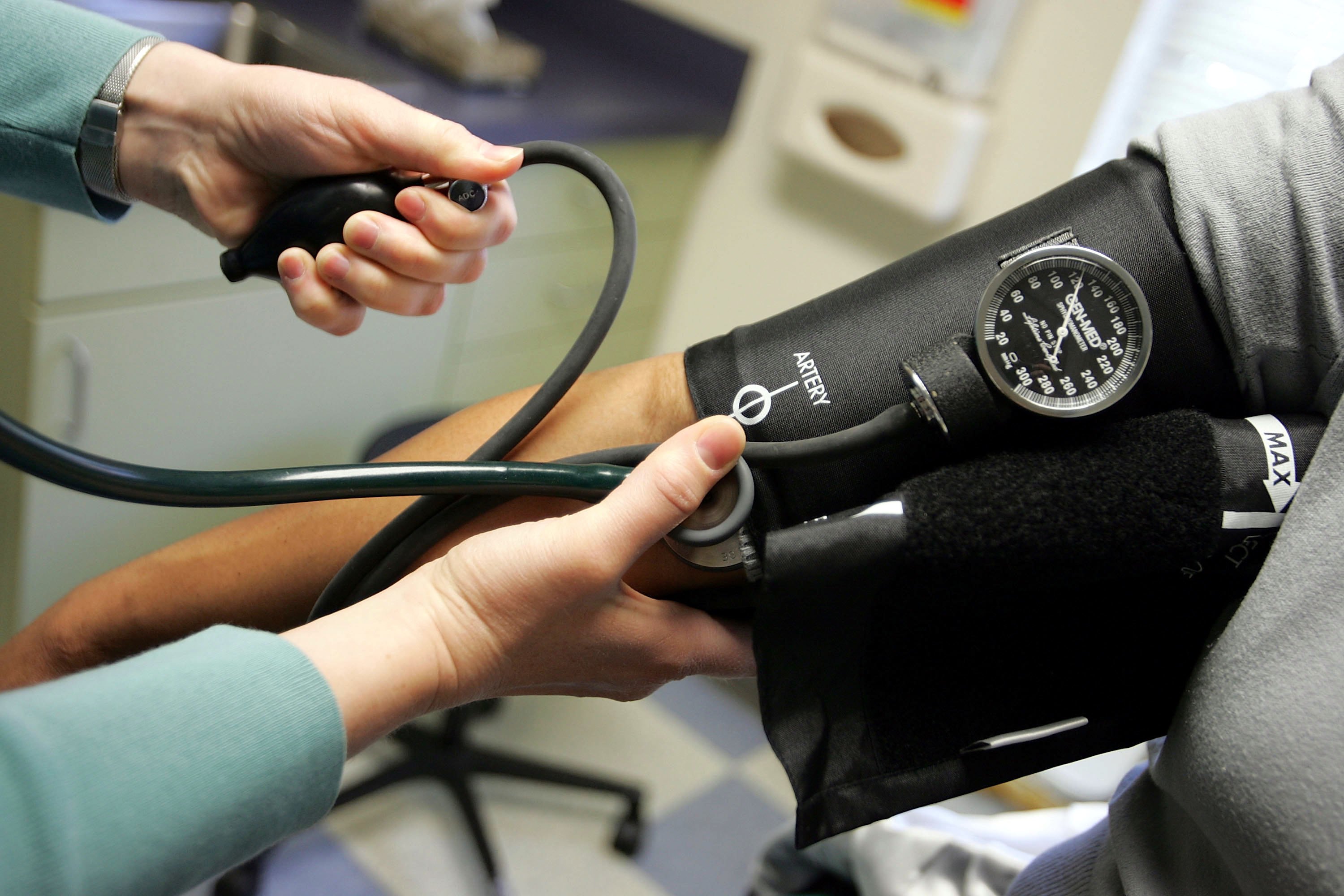 DORCHESTER, MA - APRIL 11: Dr. Elizabeth Maziarka reads a blood pressure gauge during an examination of patient June Mendez at the Codman Square Health Center April 11, 2006 in Dorchester, Massachusetts. Massachusetts Governor Mitt Romney is scheduled to sign a health care reform bill April 12 that would make it the first state in the nation to require all its citizens have some form of health insurance. (Photo by Joe Raedle/Getty Images)