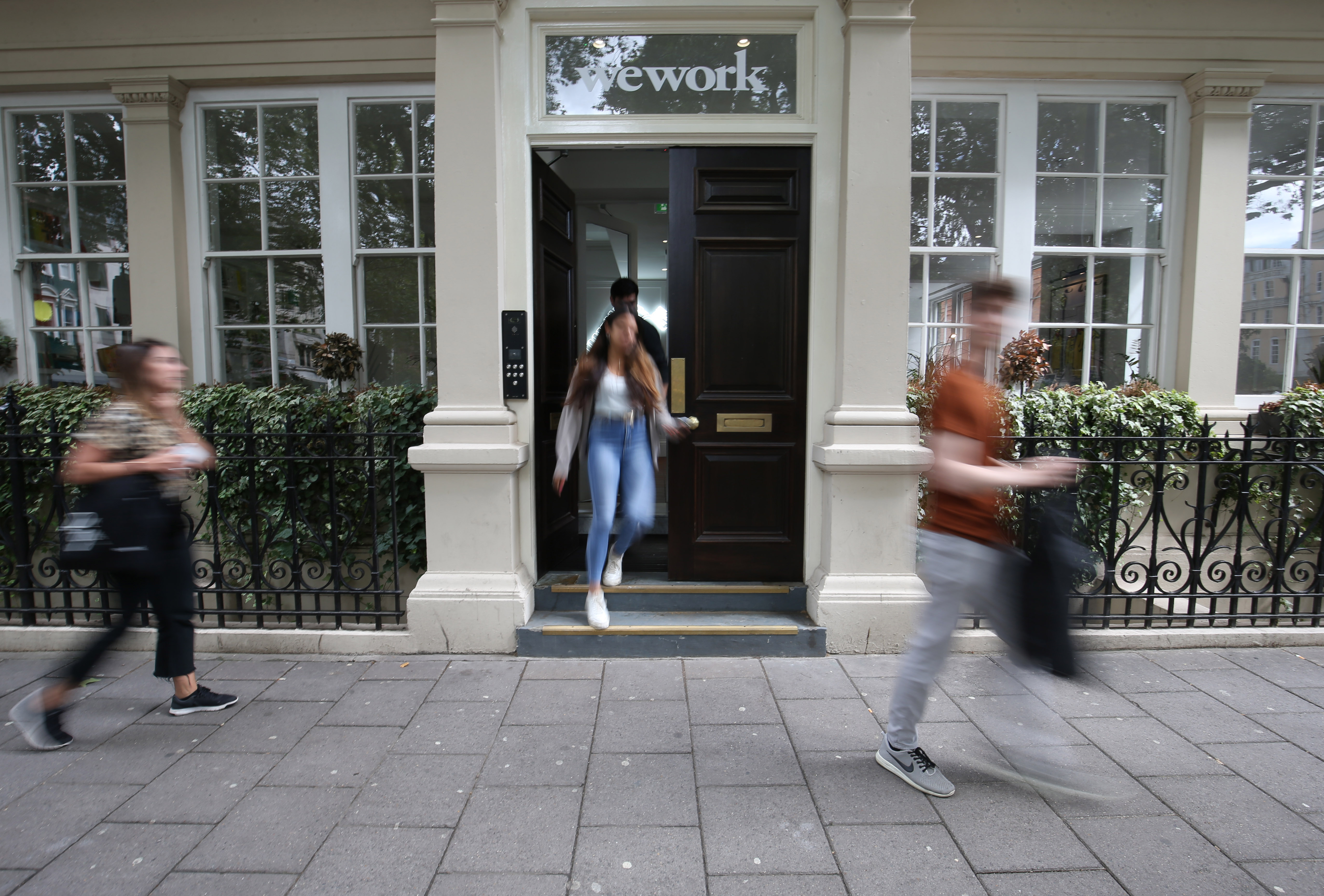 Signage outside the co-working office space group, WeWork, at Soho Square,London. (Photo by Jonathan Brady/PA Images via Getty Images)