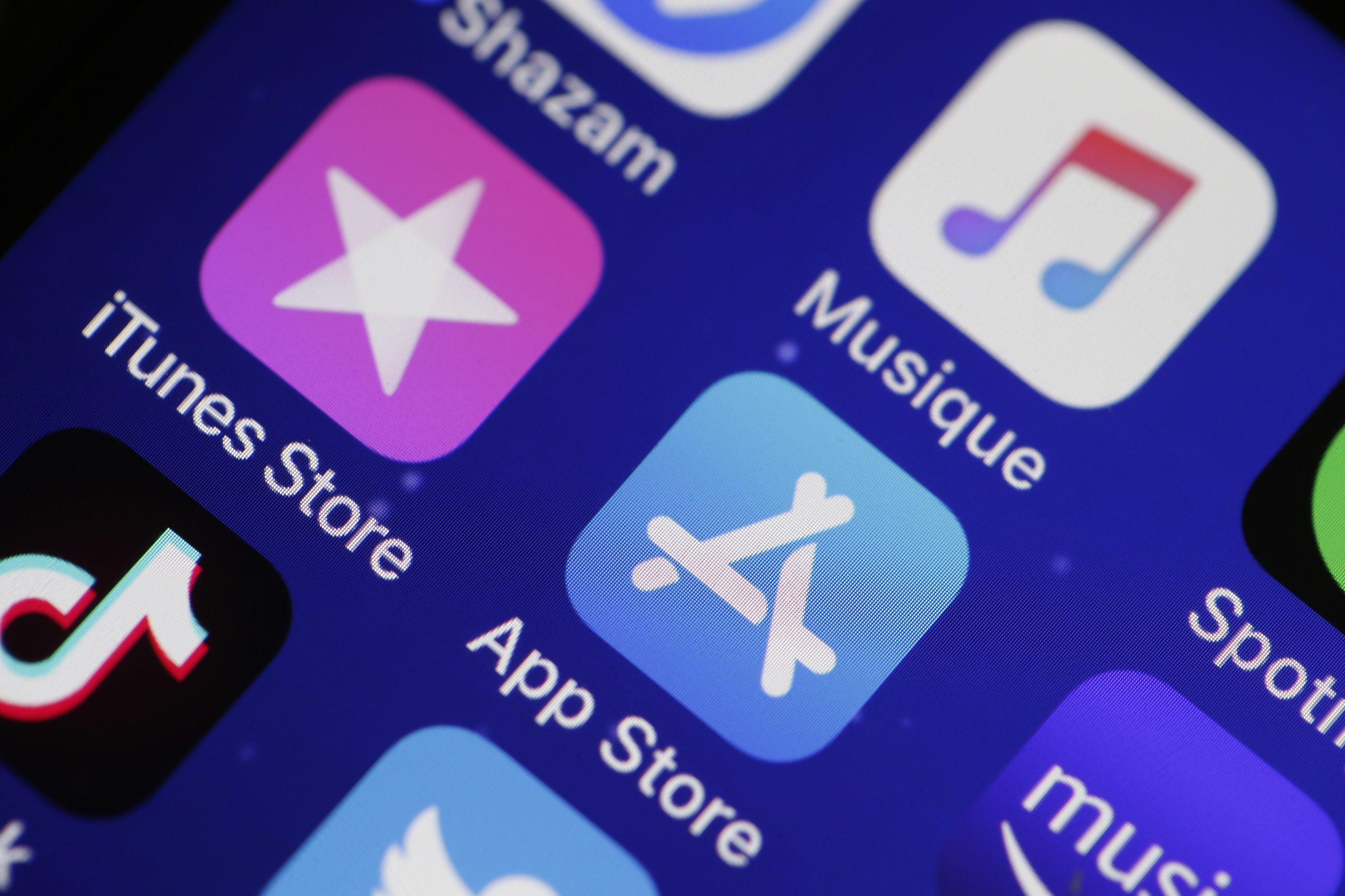 PARIS, FRANCE - JUNE 03: In this photo illustration, the logos of the applications, iTunes Store, App Store and iTunes are displayed on the screen of an iPhone on June 03, 2019 in Paris, France. The multimedia application iTunes should disappear tonight at the end of the opening conference of the WWDC held Monday, June 3 in San Jose (California). According to information from several American reference media, the Apple computer group will replace the platform with a trio of independent applications for Mac each responding to a dedicated use: Music, TV and Podcasts. (Photo by Chesnot/Getty Images)
