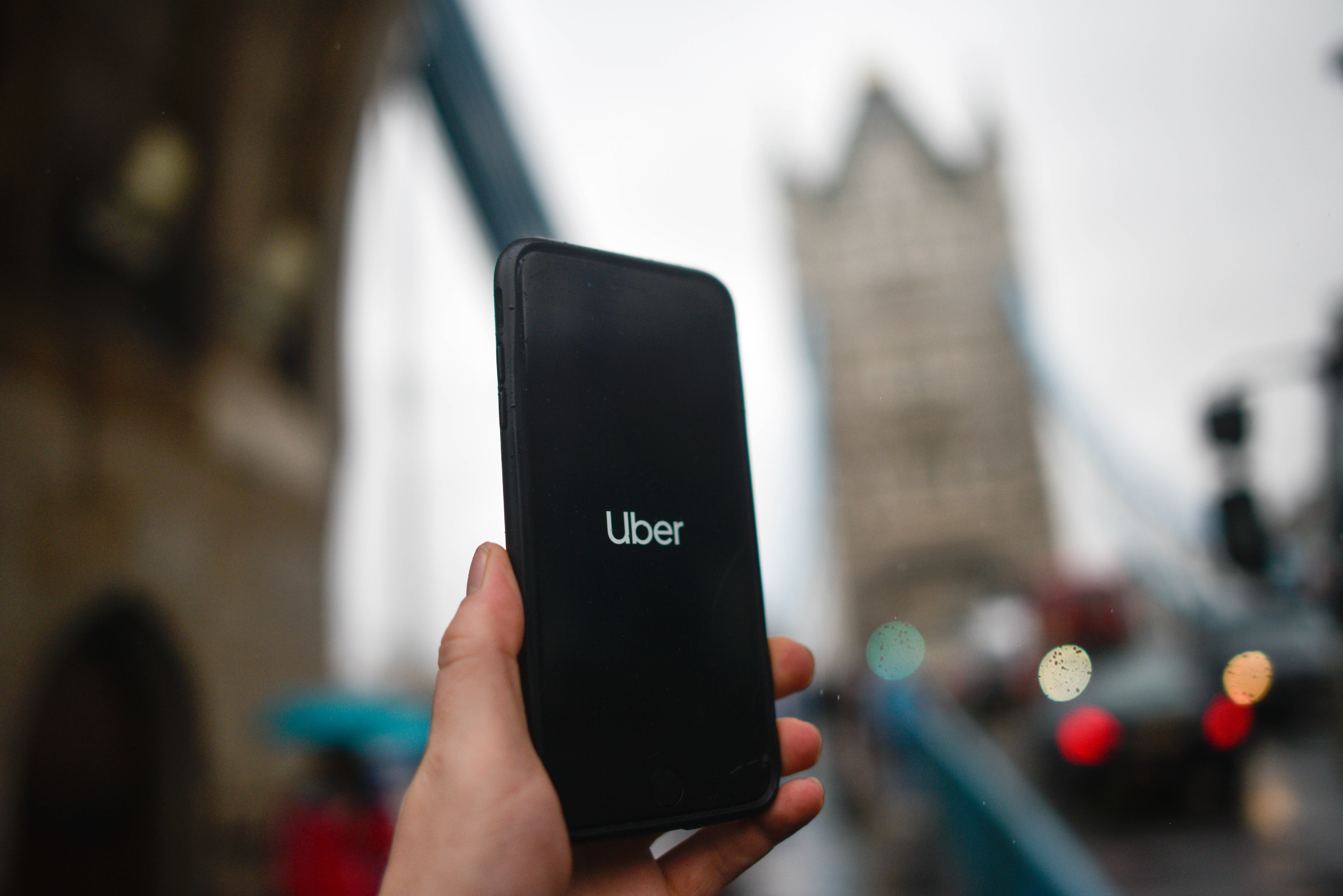 LONDON, ENGLAND - NOVEMBER 25: In this photo illustration the Uber logo is displayed on a phone in front of Tower Bridge on November 25, 2019 in London, England. Transport for London announced today, Monday, that Uber's license won't be renewed after it expires at the end of this month, November. Uber announced that they will appeal the decision. (Photo by Peter Summers/Getty Images)