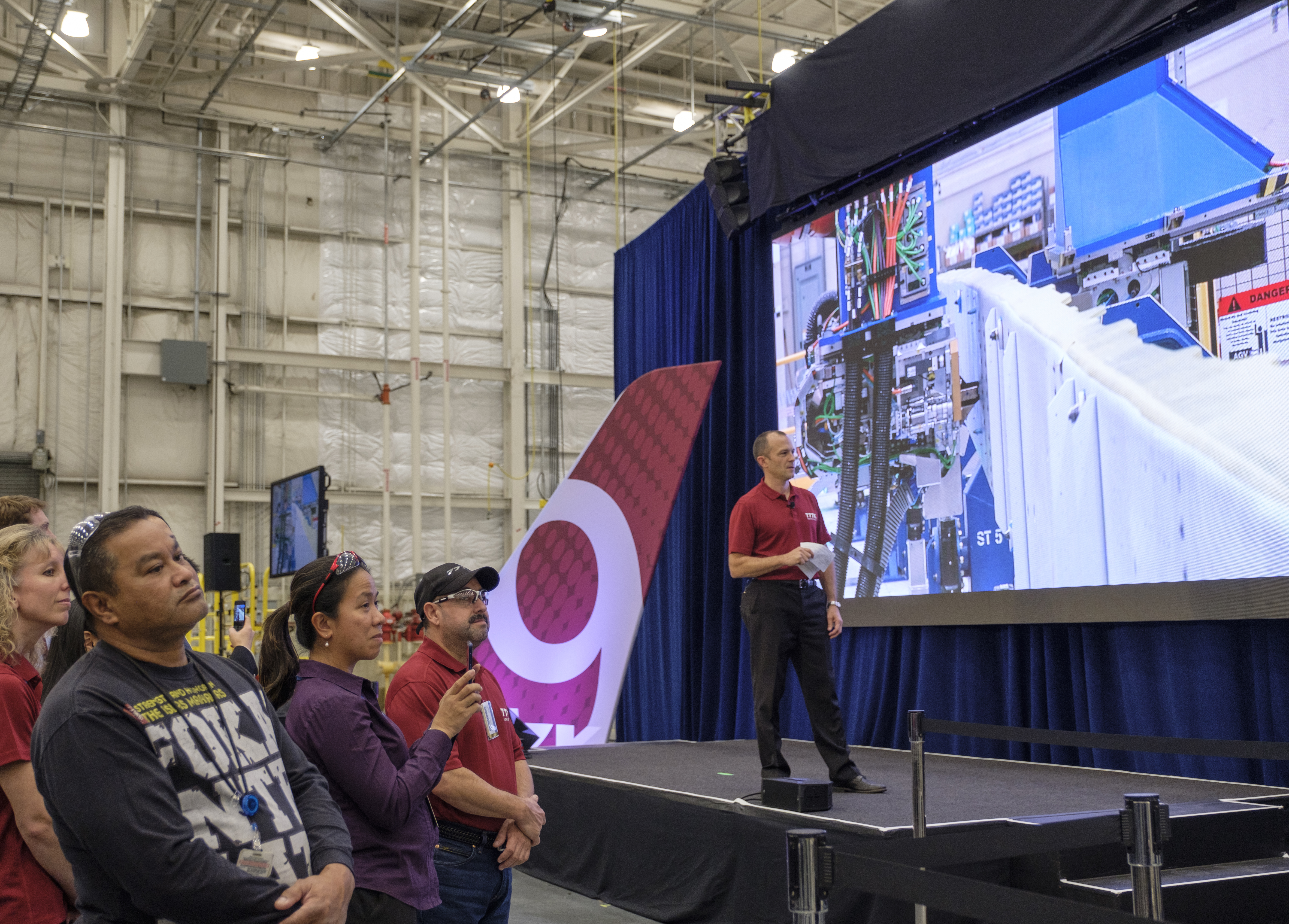 EVERETT, WA - OCTOBER 23: Boeing employees and Jason Clark, Boeing vice president of 777/777X Operations, watch as a wing spar assembly robot, on scree, begins production on the first Boing 777X airplane, on October 23, 2017 in Everett, Washington. The 777X jetliner, which will feature many of the fuel-saving innovation of the Boeing 787. (Photo by Stephen Brashear/Getty Images)