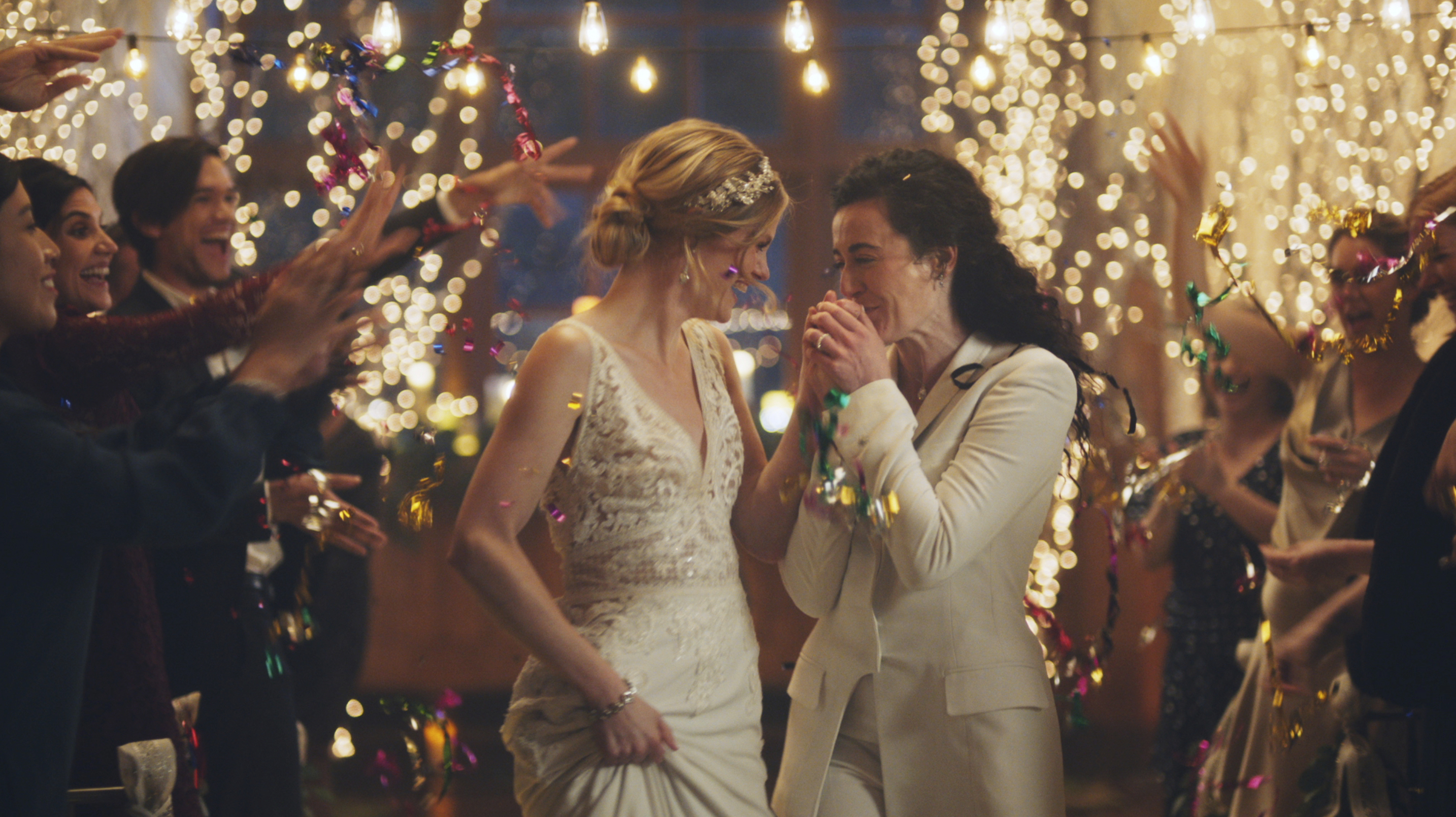 This image made from undated video provided by Zola shows a scene of its advertisement. The Hallmark Channel says it will reinstate same-sex marriage commercials that it had pulled from the network. Hallmark Cards CEO Mike Perry said in a statement Sunday, Dec. 15, 2019, that pulling the commercials “was the wrong decision." (Zola via AP)