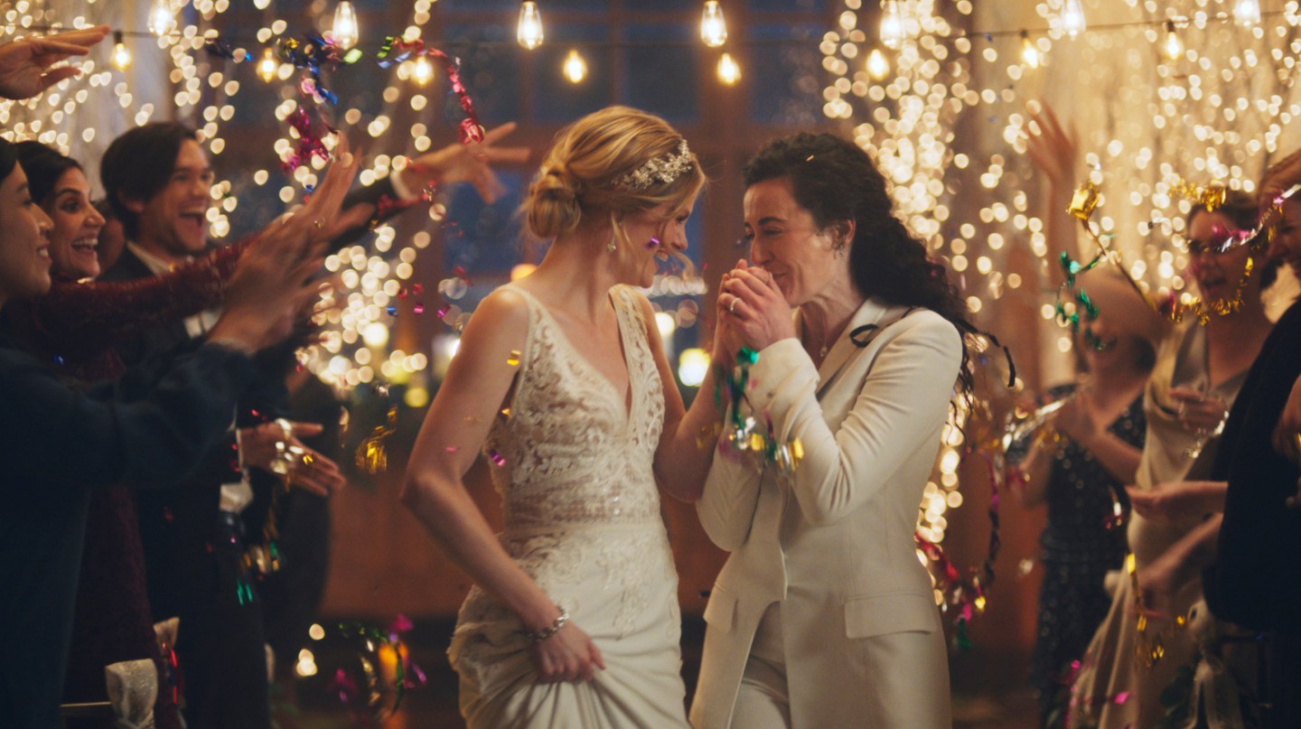 This image made from undated video provided by Zola shows a scene of its advertisement. The Hallmark Channel says it will reinstate same-sex marriage commercials that it had pulled from the network. Hallmark Cards CEO Mike Perry said in a statement Sunday, Dec. 15, 2019, that pulling the commercials “was the wrong decision." (Zola via AP)