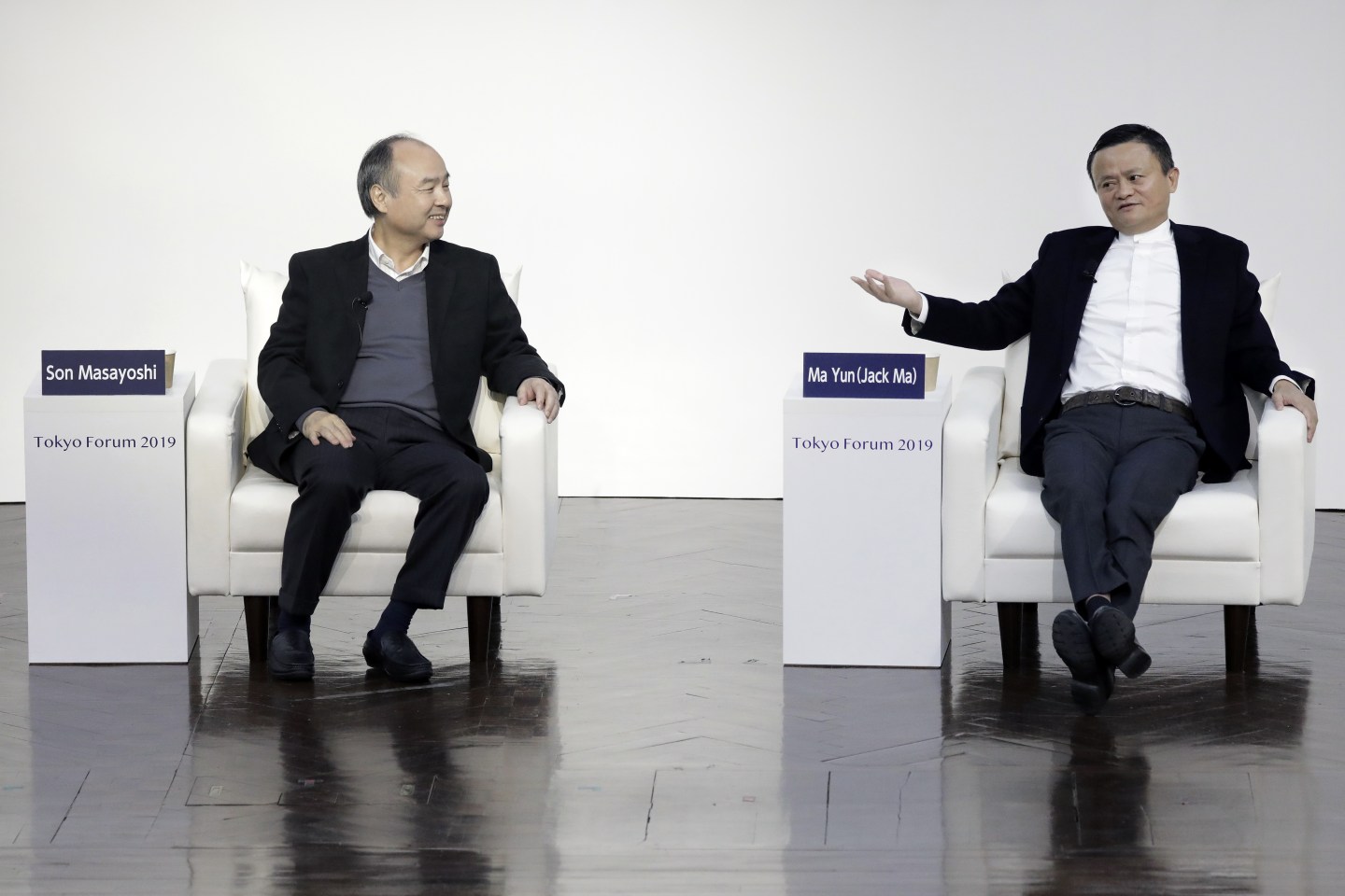 Jack Ma, former chairman of Alibaba Group Holding Ltd., right, gestures while speaking with Masayoshi Son, chairman and chief executive officer of SoftBank Group Corp., at Tokyo Forum 2019 in Tokyo, Japan, on Friday, Dec. 6, 2019. Son unveiled a $184 million initiative Friday to accelerate artificial intelligence research in Japan, enlisting Ma to expound on his goal of commercializing the technology. Son's company announced a partnership with the University of Tokyo that includes spending 20 billion yen ($184 million) over 10 years by mobile arm SoftBank Corp. to establish the Beyond AI Institute. Photographer: Kiyoshi Ota/Bloomberg via Getty Images