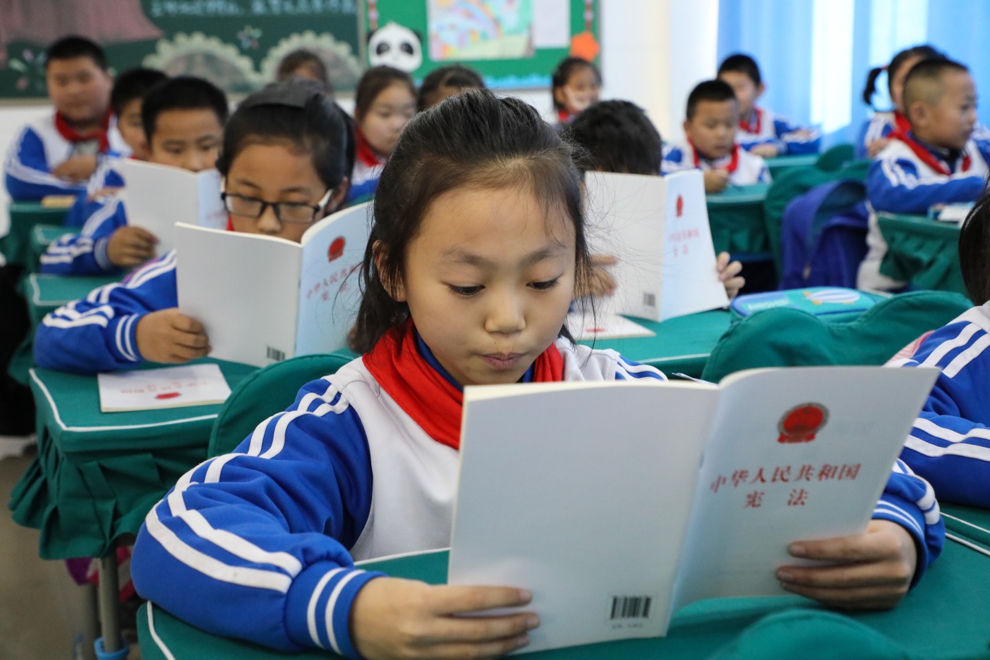 DONGYING, CHINA - DECEMBER 03: Primary school students read the Constitution of the People's Republic of China on December 3, 2019 in Dongying, Shandong Province of China. National Constitution Day of China falls on December 4 every year. (Photo by Song Xinggang/VCG via Getty Images)