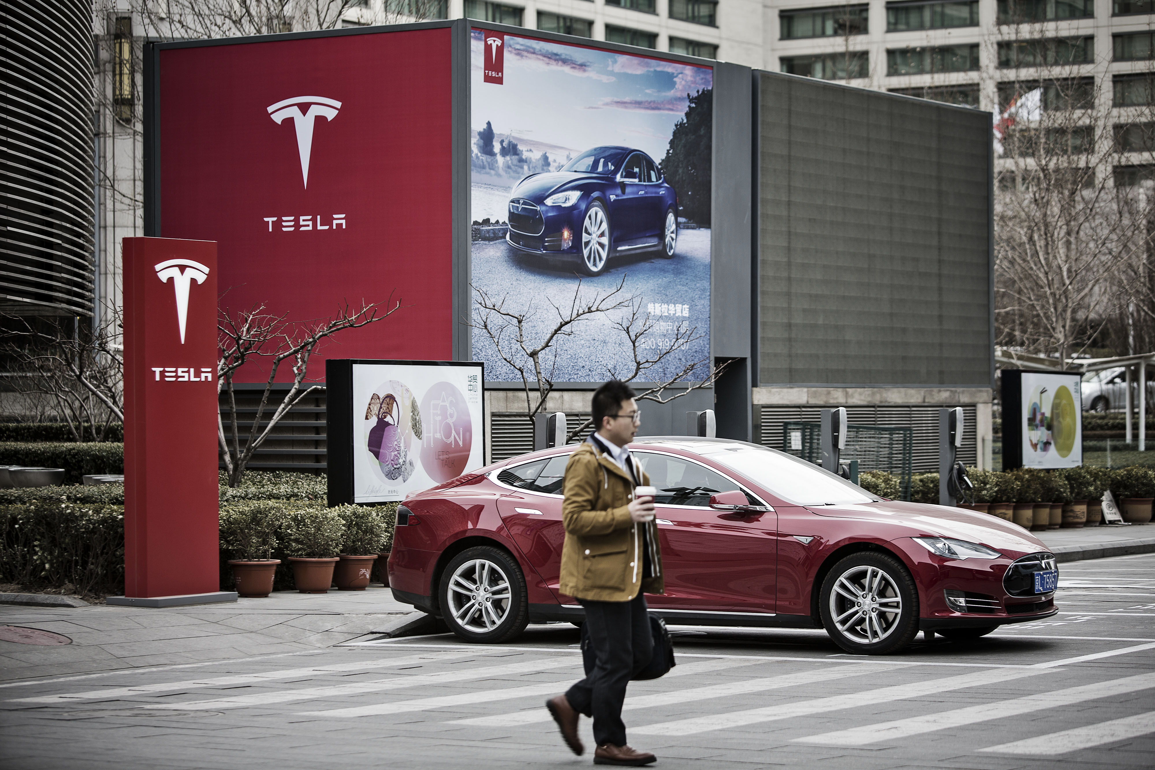 A Tesla Motors Model S electric automobile at one of the company's electric charging stations in Beijing.