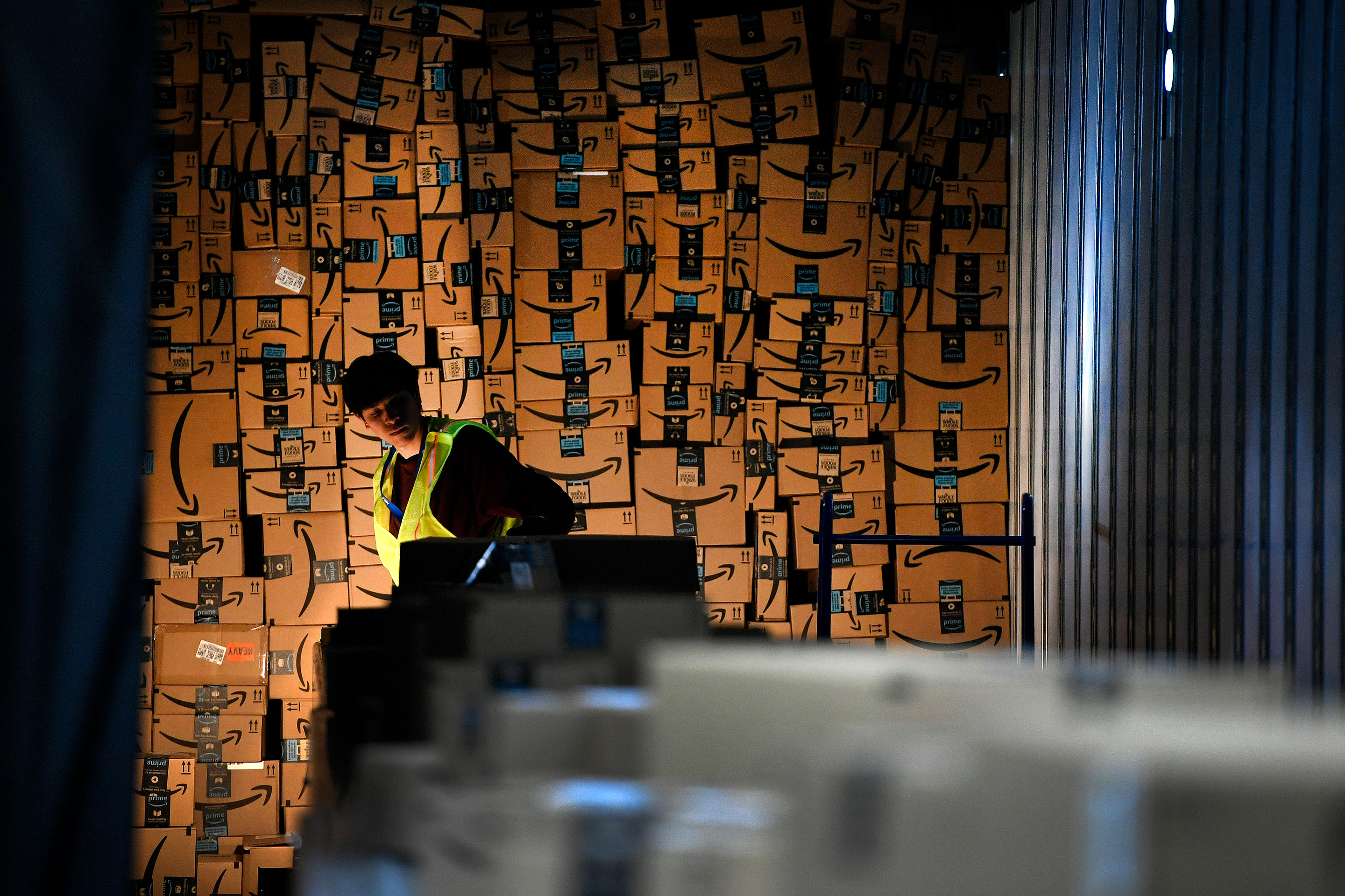 Jared Villarreal loads boxes into a trailer of a truck to be shipped out at Amazon's Fulfillment Center on March 19, 2019 in Thornton, Colorado.