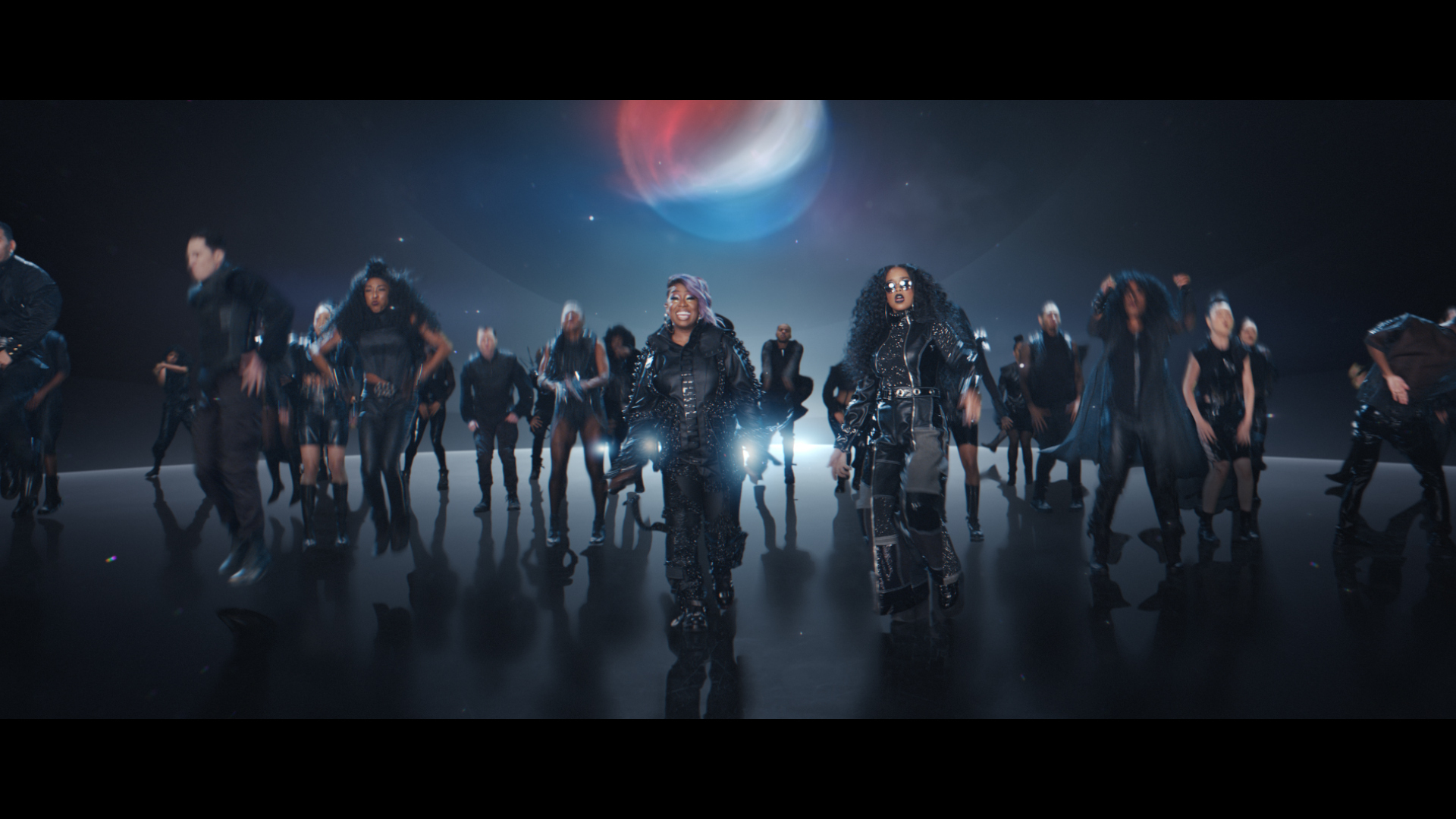 This undated image provided by PepsiCo shows Missy Elliott, center left, and H.E.R., center, right, in a scene from the company's 2020 Super Bowl NFL football spot. Pepsi tries to reignite the Cola Wars with Missy Elliott and H.E.R. performing an updated version of “Paint it Black” that starts with a red cola can that looks like a Coke changing into a black can of Pepsi Zero Sugar to the lyrics of “I see a red door and I want it painted black.” (PepsiCo via AP)