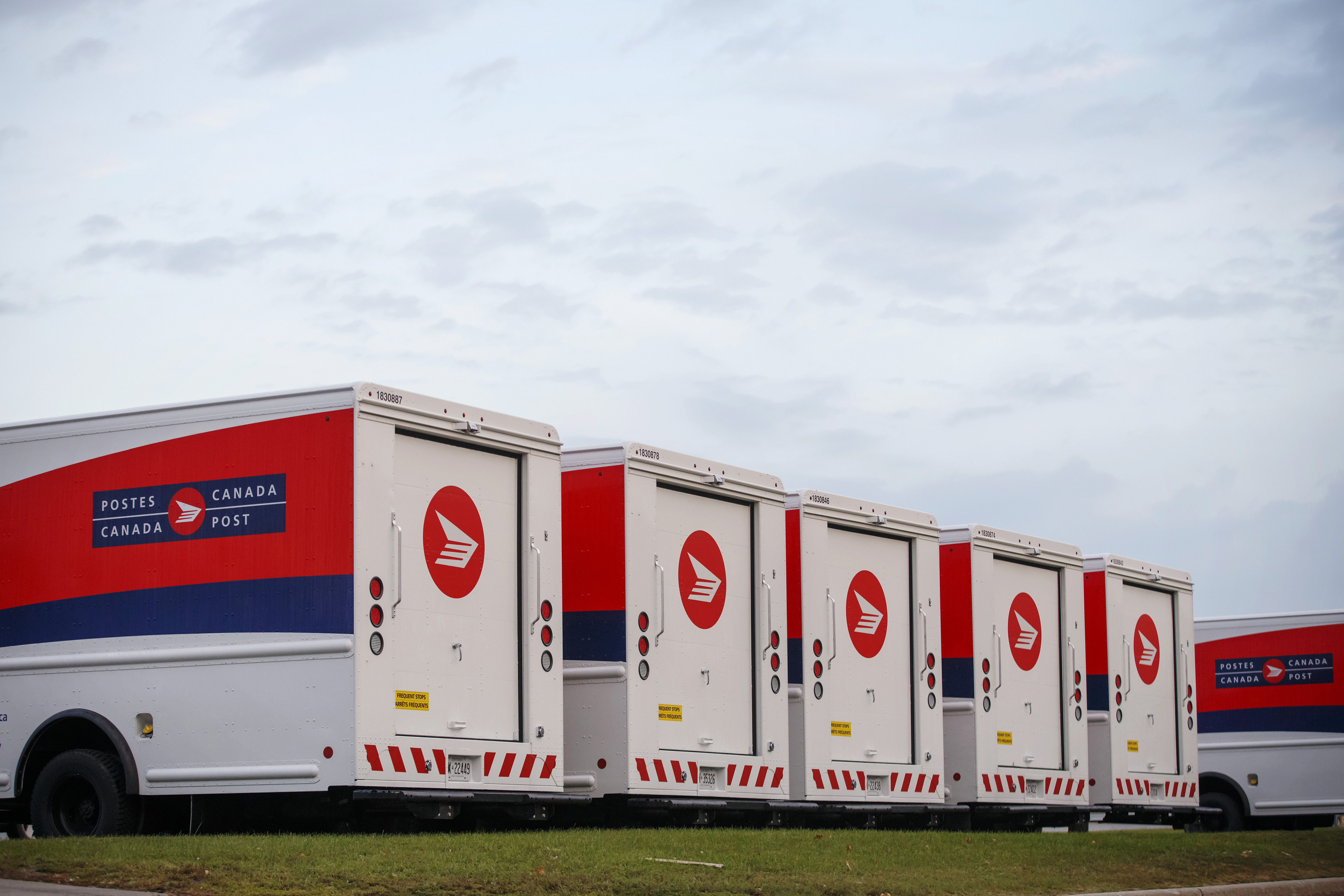 Canada Post Corp. mail delivery trucks sit in the Gateway Postal Facility parking lot during a Canadian Union of Postal Workers (CUPW) strike in Toronto, Ontario, Canada, on Tuesday, Oct. 23, 2018. CUPW members in the Toronto local have begun a second day of postal disruptions across the country and almost 9,000 postal workers will walk off the job at midnight on Tuesday. Photographer: Cole Burston/Bloomberg via Getty Images