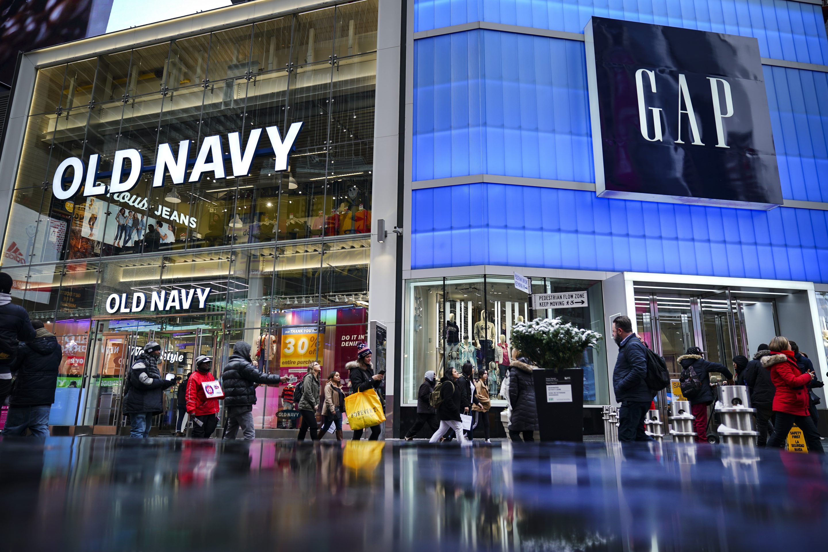 NEW YORK, NY - MARCH 01: Pedestrians walk past Old Navy and GAP stores in Times Square, March 1, 2019 in New York City. On Thursday, Gap Inc. announced plans to separate into two publicly traded companies, spinning off Old Navy into a separate firm as it closes about 230 Gap stores over the next two years. According to Gap Inc., Old Navy will become its own company, and the other company, which has not been named yet, will consist of the Gap brand, Athleta, Banana Republic, Intermix and Hill City. (Photo by Drew Angerer/Getty Images)