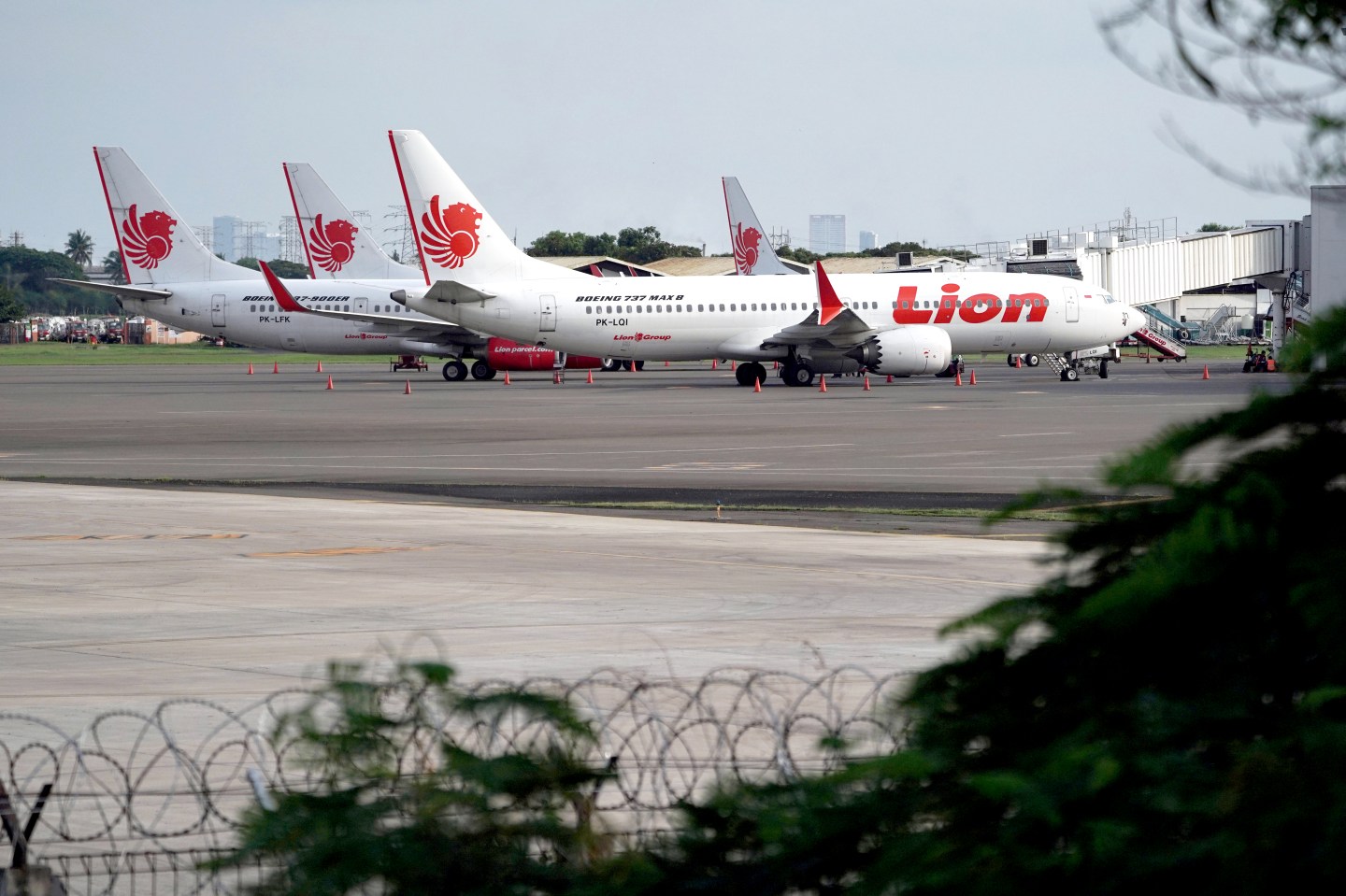 A Lion Air Boeing Co. 737 Max 8 aircraft, right, stands on the tarmac at Soekarno-Hatta International Airport in Cenkareng, Indonesia, on Tuesday, March 12, 2019. Indonesias Lion Air, one of the biggest customers of Boeings 737 Max plane, is suspending delivery of four of the jets it had on order for this year after the second fatal accident involving the model in five months. Photographer: Dimas Ardian/Bloomberg via Getty Images