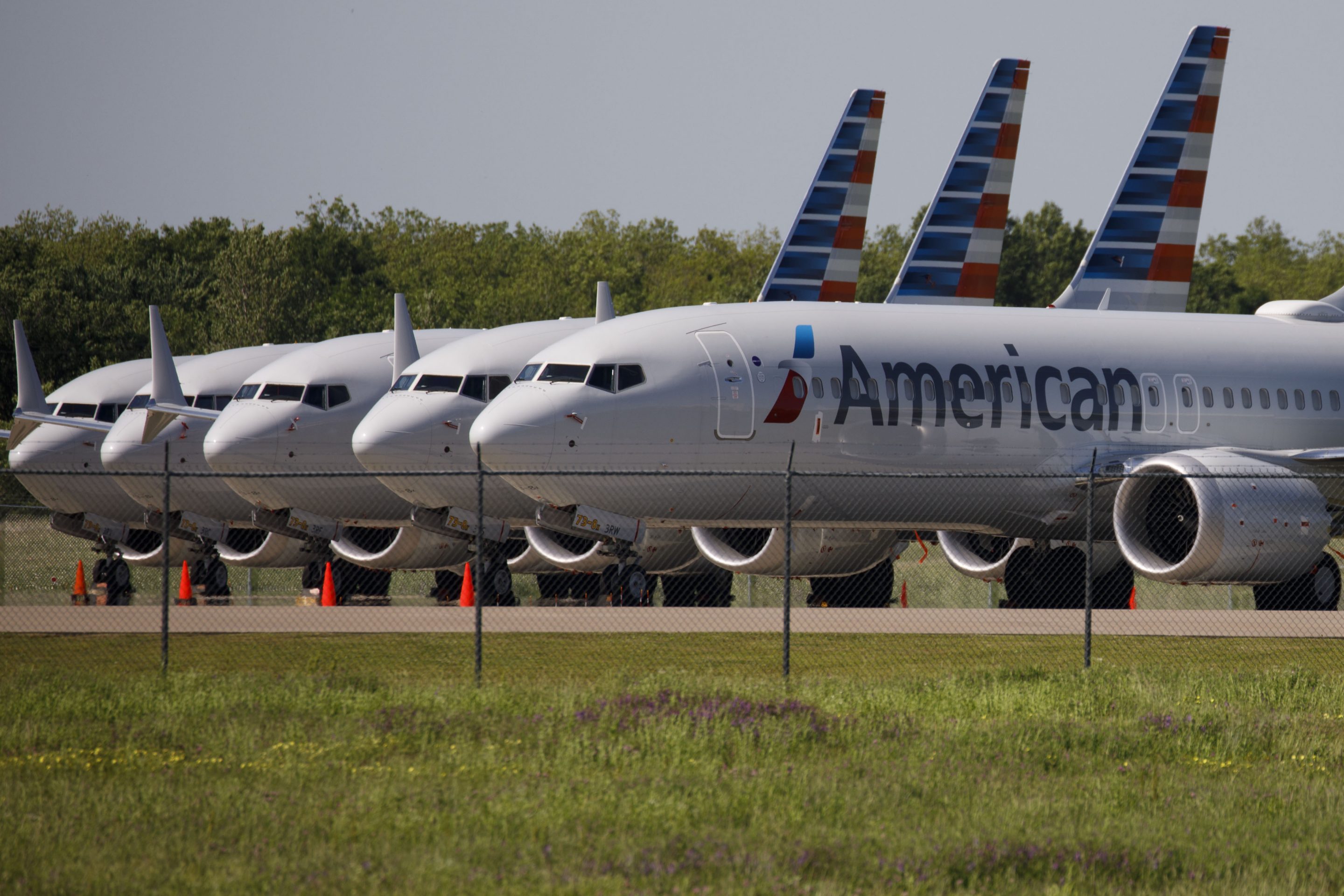 American Airlines Group Inc. Boeing Co. 737 Max planes sit parked outside of a maintenance hangar at Tulsa International Airport (TUL) in Tulsa, Oklahoma, U.S., on Tuesday, May 14, 2019. Three unions representing aviation safety inspectors said in a sharply worded report months before the Boeing's 737 Max was approved for use that the planemaker was given too much authority to oversee itself and that the new jet had safety flaws. Photographer: Patrick T. Fallon/Bloomberg via Getty Images