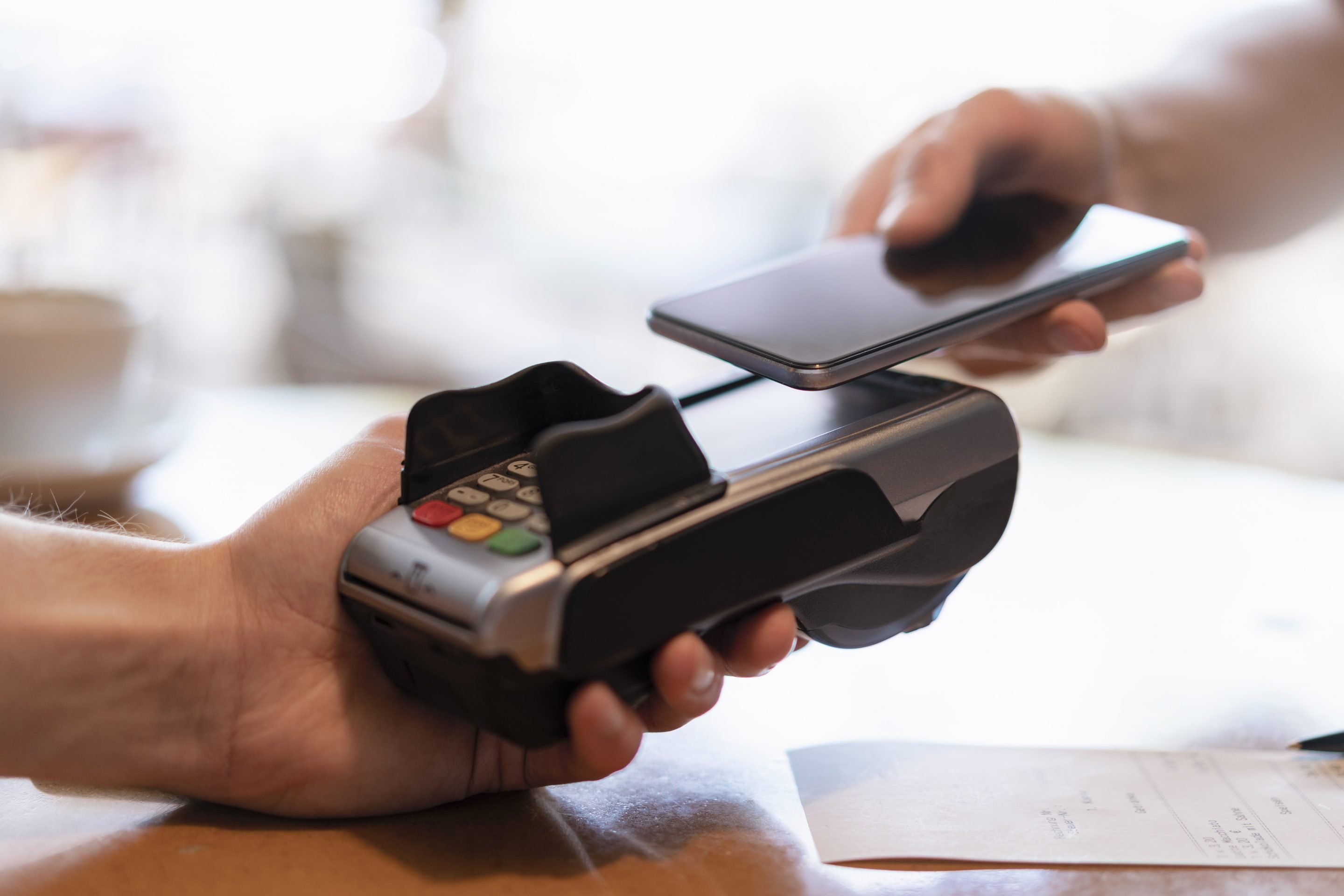 Contactless payment with smartphone, close-up Westend61—Getty Images