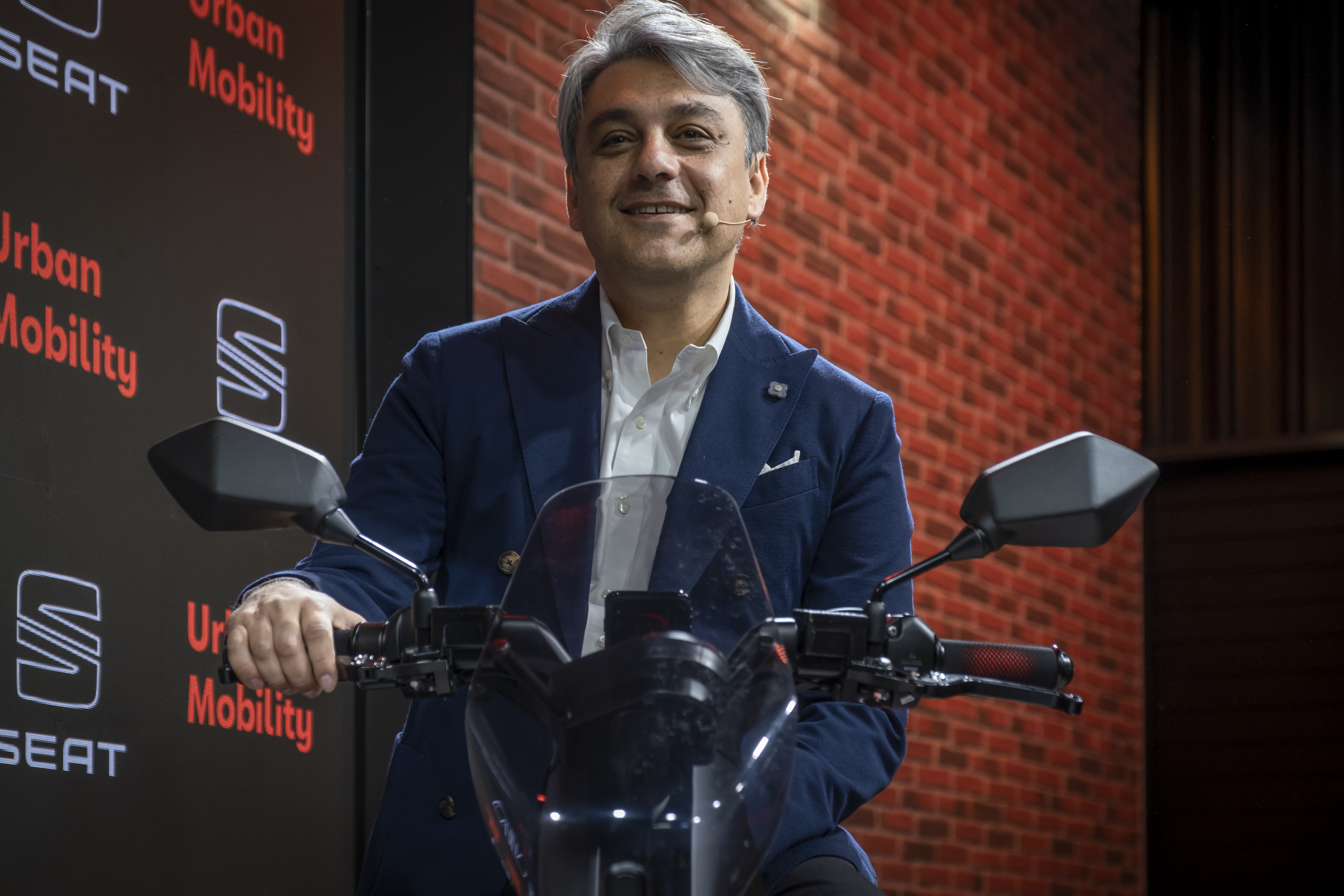 New Renault CEO Luca de Meo presents the SEAT e-scooter motorcycle during an expo in November 2019.