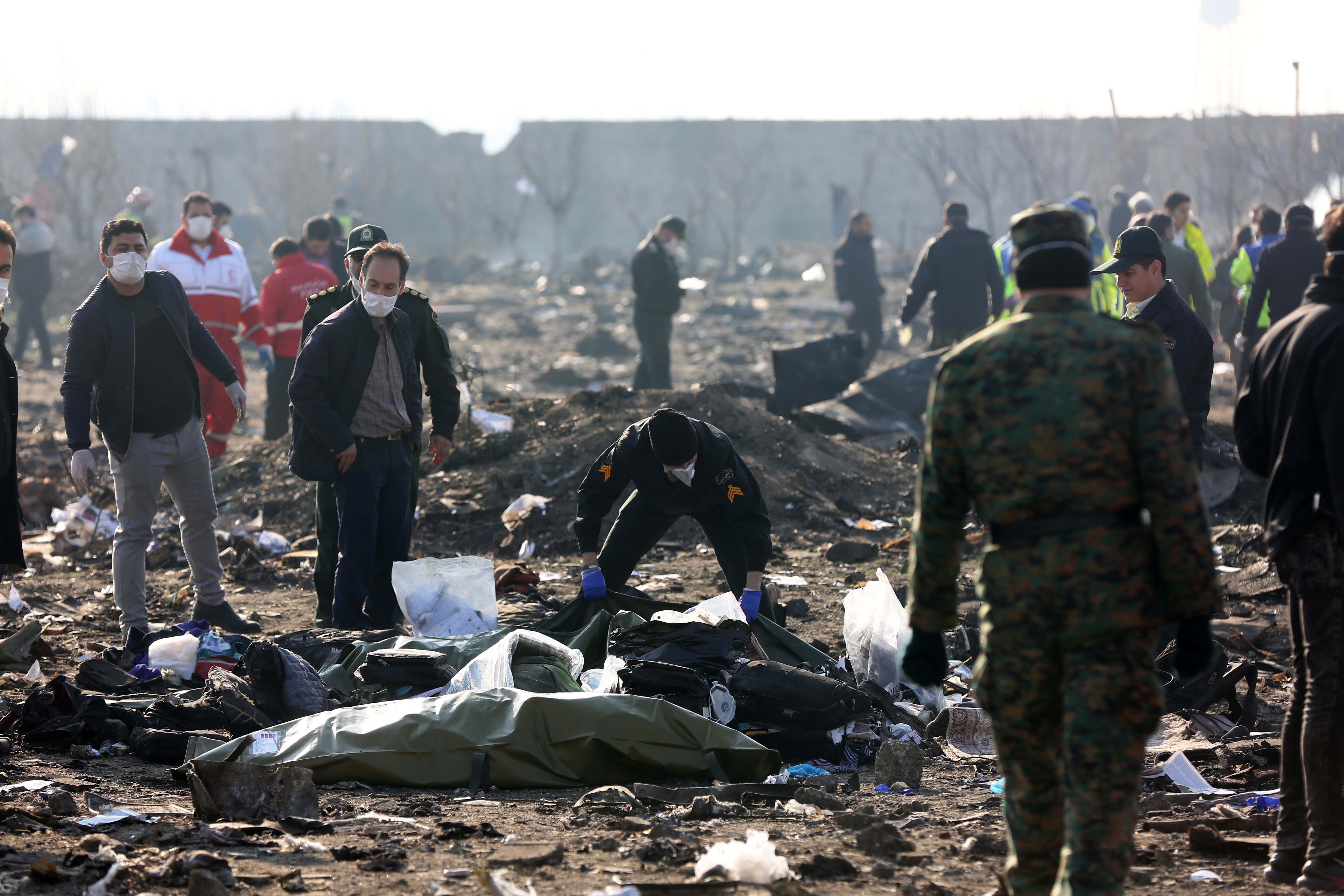 TEHRAN, IRAN - JANUARY 08: Search and rescue works are conducted at site after a Boeing 737 plane belonging to a Ukrainian airline crashed near Imam Khomeini Airport in Iran just after takeoff with 180 passengers on board in Tehran, Iran on January 08, 2020. All 167 passengers and nine crew members on an Ukrainian 737 plane that crashed near Iran's capital Tehran early Wednesday have died, according to a state official. (Photo by Fatemeh Bahrami/Anadolu Agency via Getty Images)