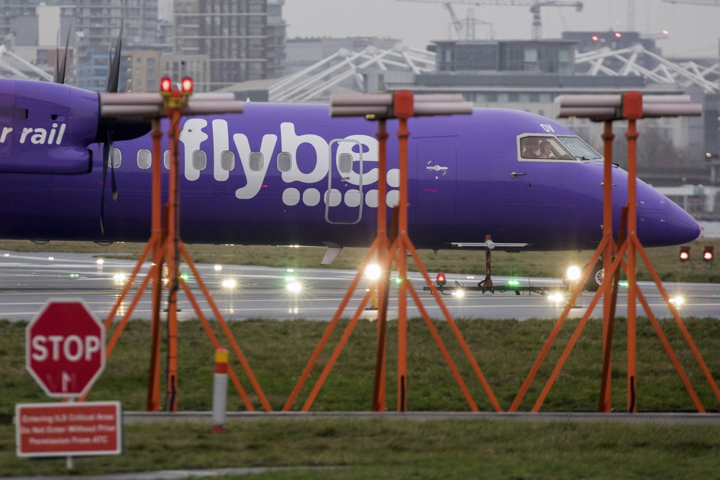 A passenger aircraft, operated by Flybe Group Plc, taxis past landing lights at London City Airport in London, U.K., on Tuesday, Jan. 14, 2020. U.K. regional airline Flybe has only days to secure a rescue package that could include help from the government, according to a person with knowledge of the talks. Photographer: Chris Ratcliffe/Bloomberg via Getty Images