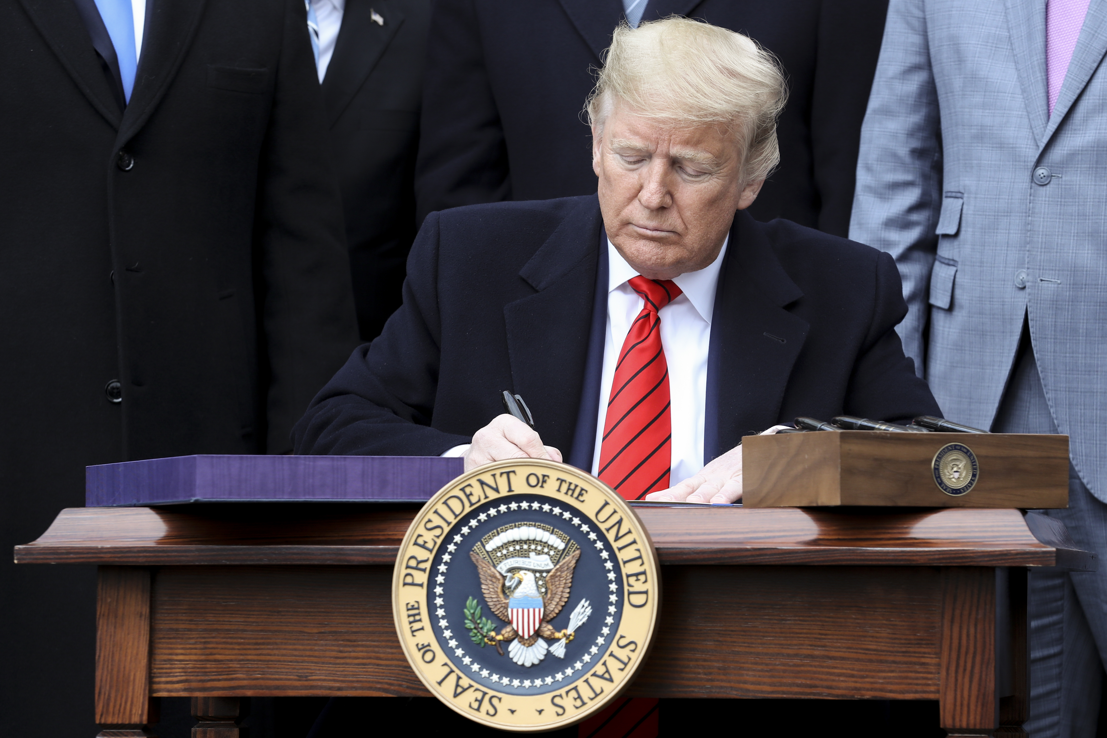 U.S. President Donald Trump signs the U.S.-Mexico-Canada Agreement (USMCA) on the South Lawn of the White House in Washington, D.C., U.S., on Wednesday, Jan. 29, 2020.