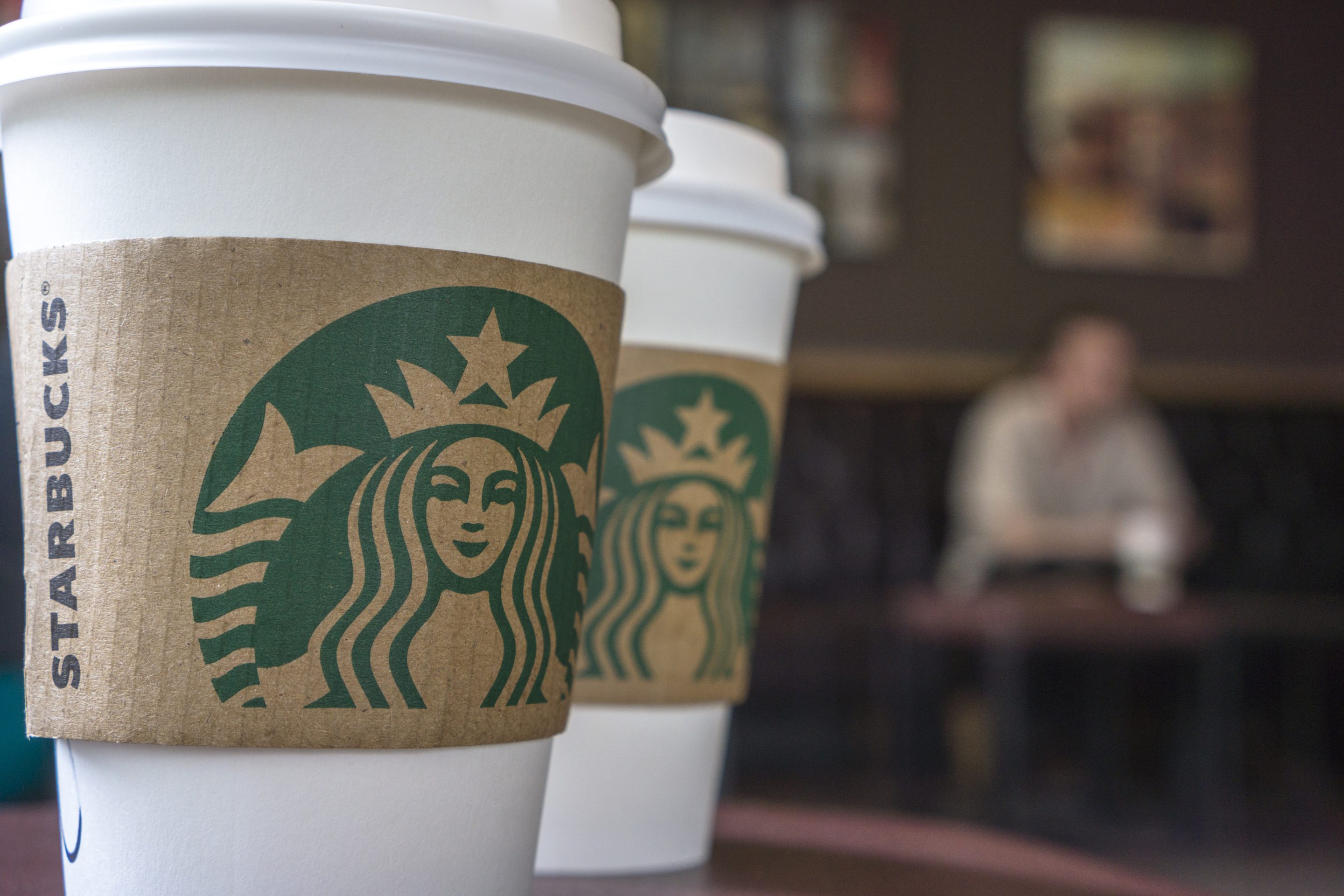 BEIJING, CHINA - 2015/07/27: Coffee cups on the table in a Starbucks shop. Last Thursday, Starbucks Corp. announced a new partnership with Lyft, which is Uber's biggest competitor, and reported a best quarter performance in history, sending the stock roaring in after-hours trading. (Photo by Zhang Peng/LightRocket via Getty Images)