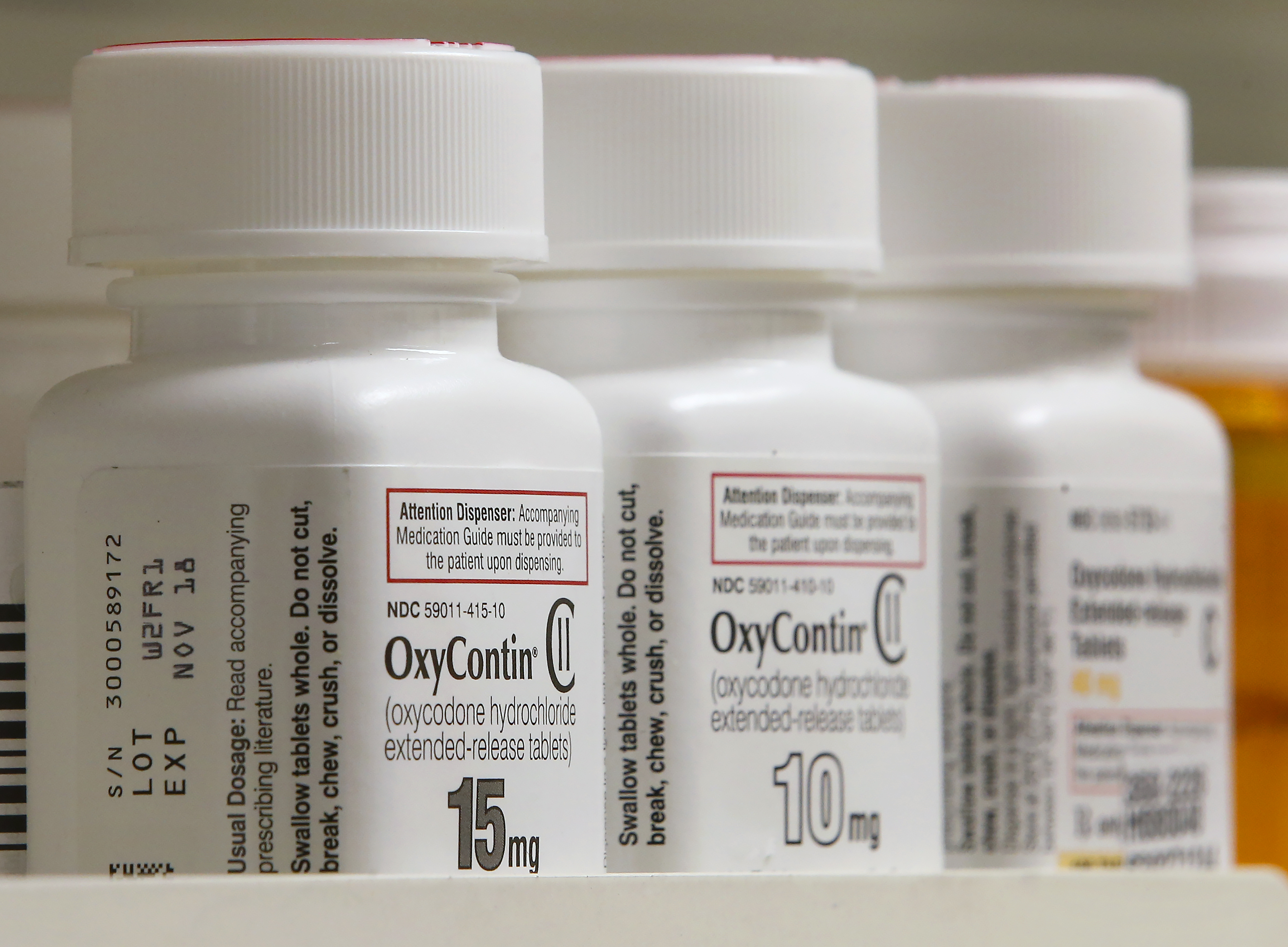 Bottles of Purdue Pharma L.P. OxyContin medication sit on a pharmacy shelf in Provo, Utah, U.S., on Wednesday, Aug. 31, 2016. A Nov. 2015 forecast from health data firm IMS Health expects global sales of brand and generic prescription drugs, and nonprescription medicines, to total $1.4 trillion in 2020. Photographer: George Frey/Bloomberg via Getty Images