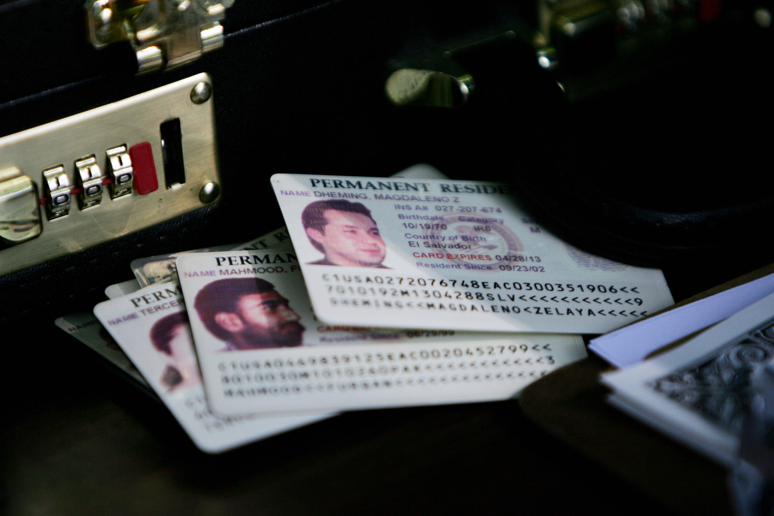 Permanent residence cards, known as green cards, rest on the check-in table as resident aliens arrive for a naturalization ceremony at George Washington's Mount Vernon in Alexandria, VA, 22 May 2006.