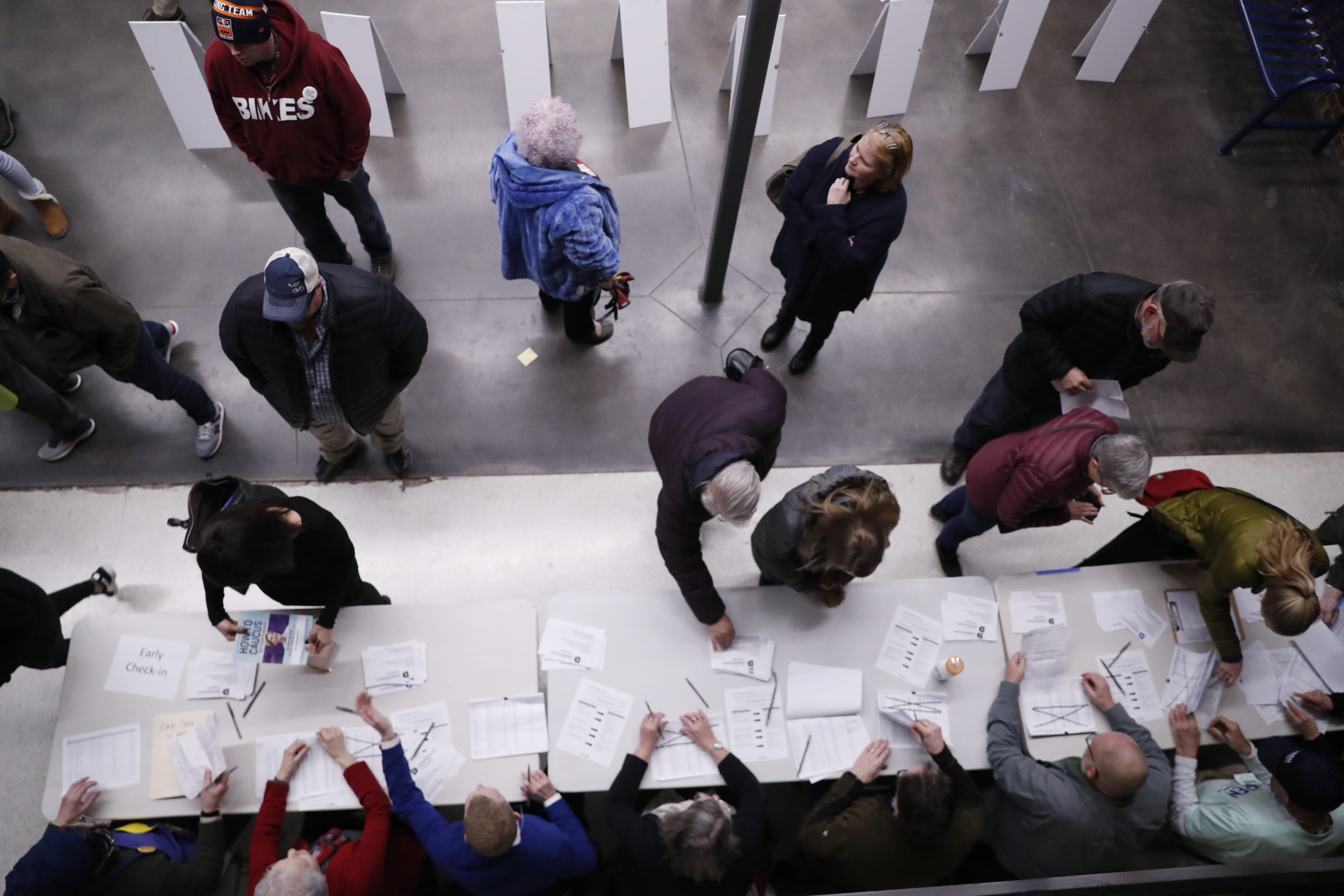 Caucus goers check in at a caucus at Roosevelt High School, Feb. 3, 2020, in Des Moines, Iowa.